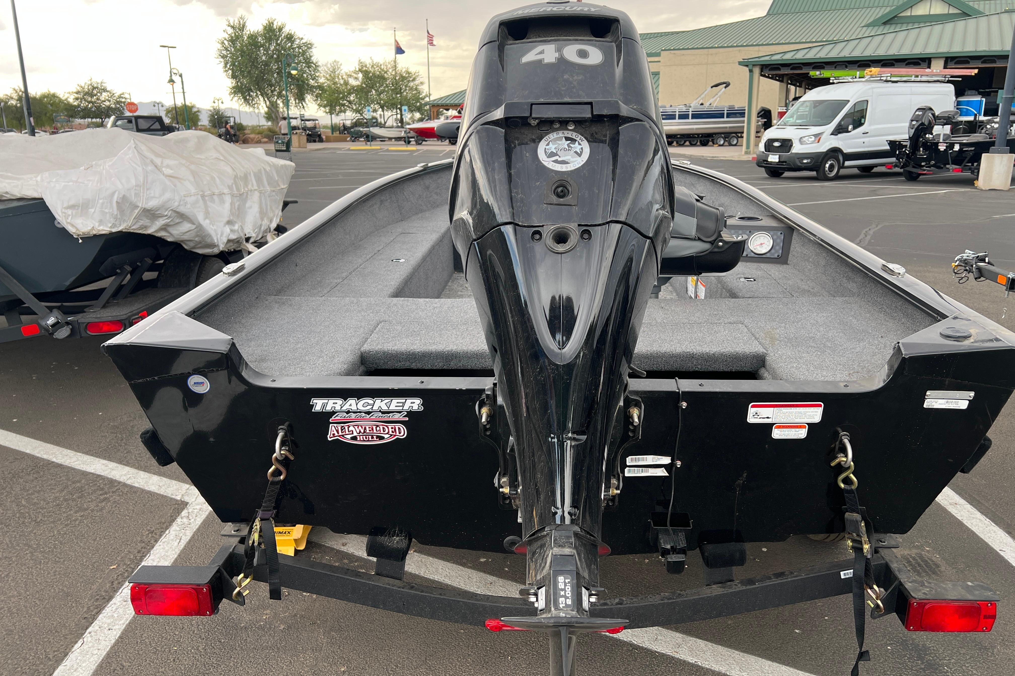 2025 Tracker Super Guide V-16 T boat with 40 HP motor in parking lot.