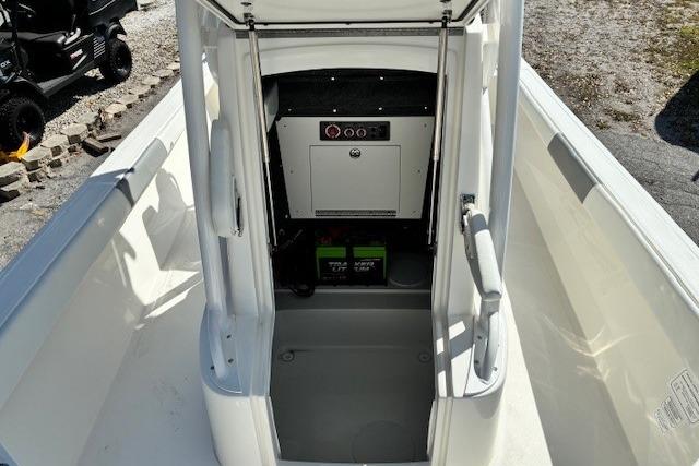 2026 Mako 24 APEX boat interior, featuring control panel and storage area.