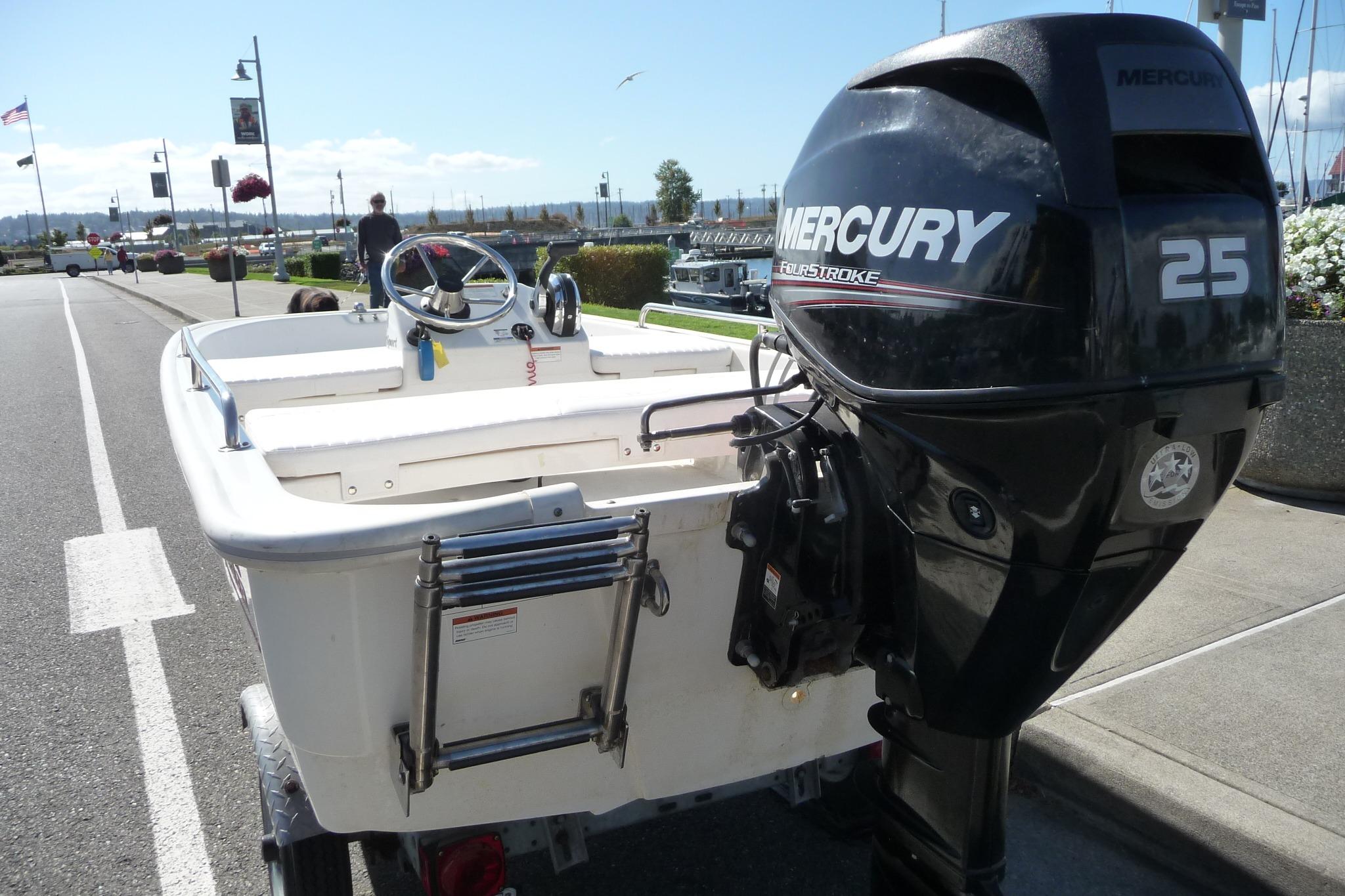 2018 Boston Whaler 110 Sport boat with Mercury 25 FourStroke engine, parked near a marina.