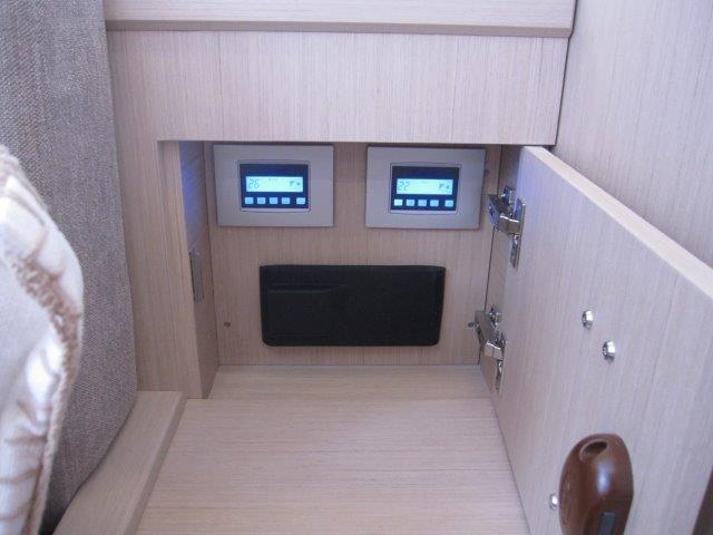 Control panel area inside 2024 Jeanneau 55 yacht with digital displays.