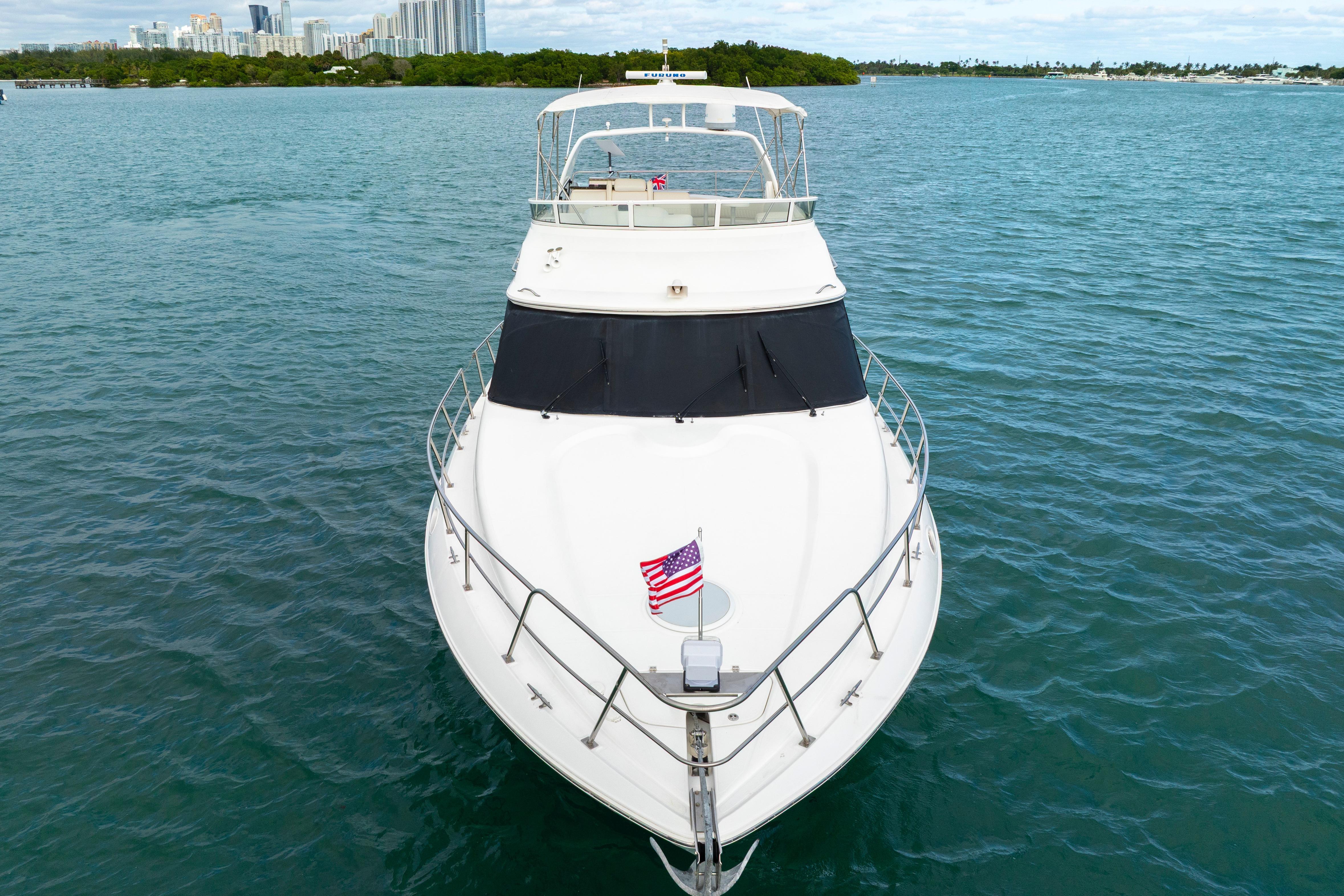 2001 Cruisers Yachts 5000 Sedan Sport on open water, American flag displayed.