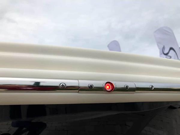 2025 Scout 215 Dorado boat with red LED light on chrome rail.