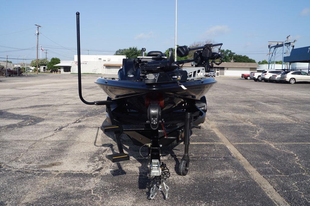 2025 Phoenix 921 Elite boat on trailer in parking lot, front view.