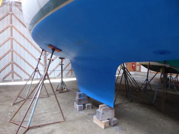 1989 Nonsuch 30 Ultra sailboat hull on stands in a boatyard.