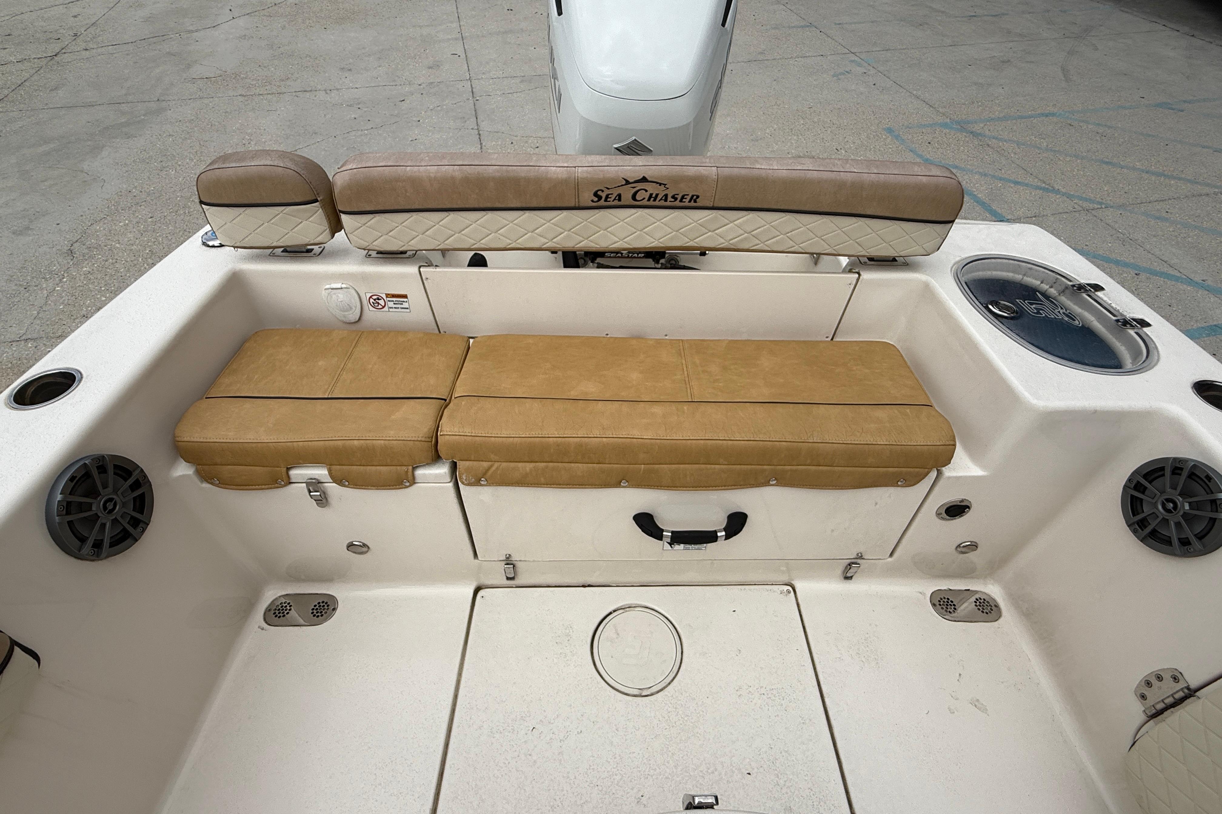 2023 SeaChaser 24 HFC boat interior with tan seating and storage compartments.