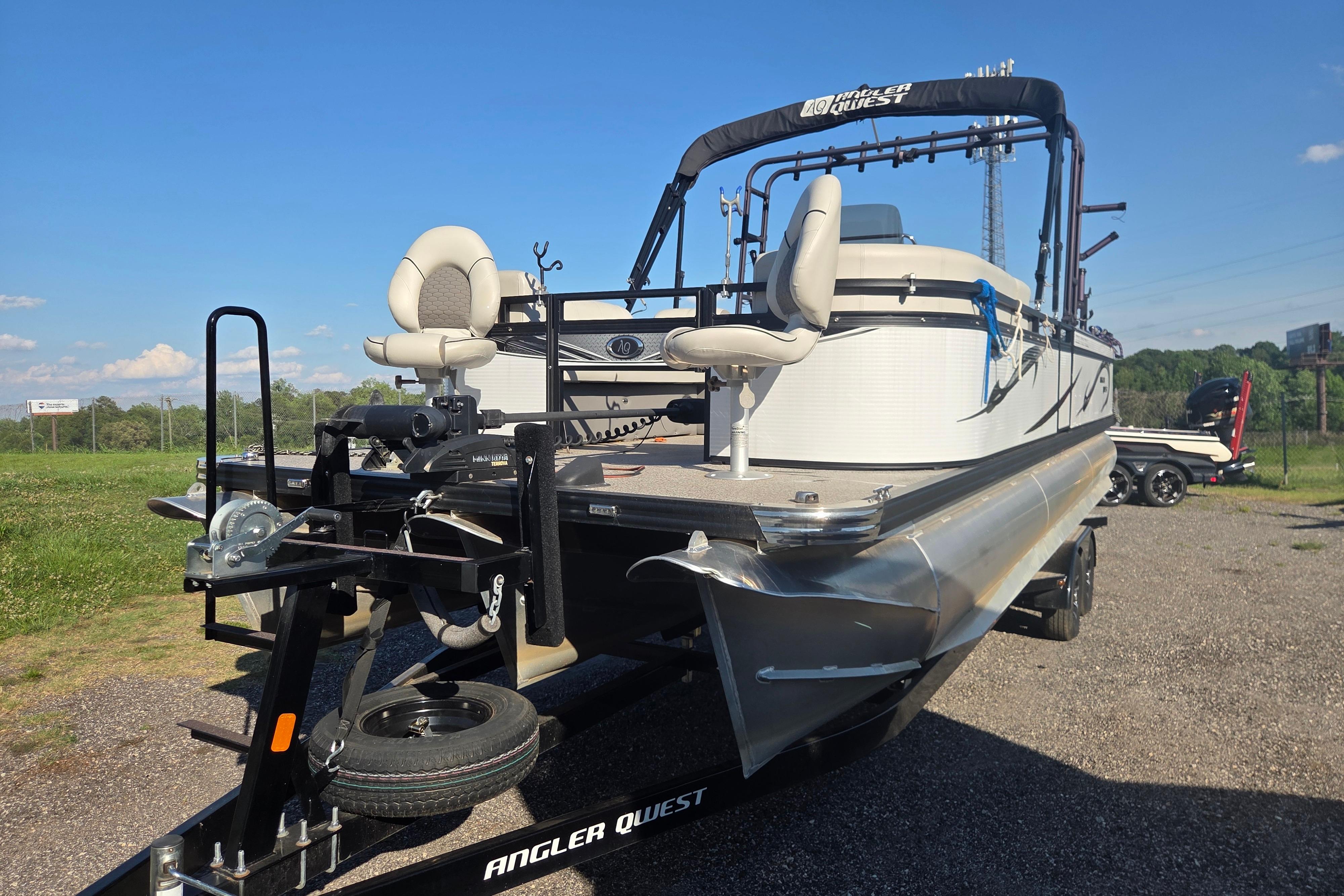 2024 Angler Qwest 8526 Pro Troll pontoon boat on trailer, sunny day.