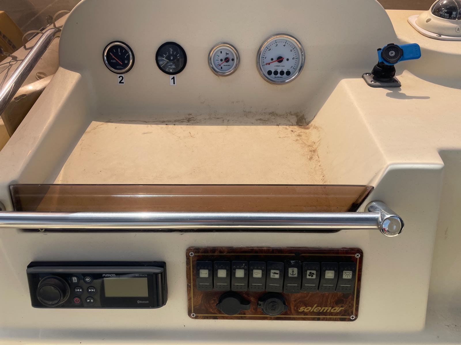 Control panel of a 2012 Solemar 23 boat with gauges and switches.