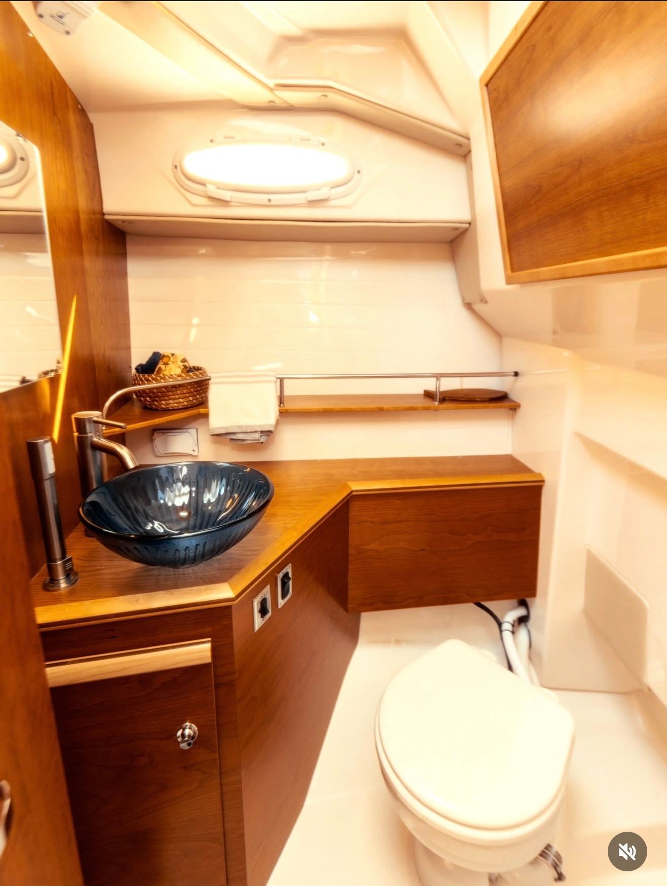 Interior of a modern boat cabin with a sink and toilet.
