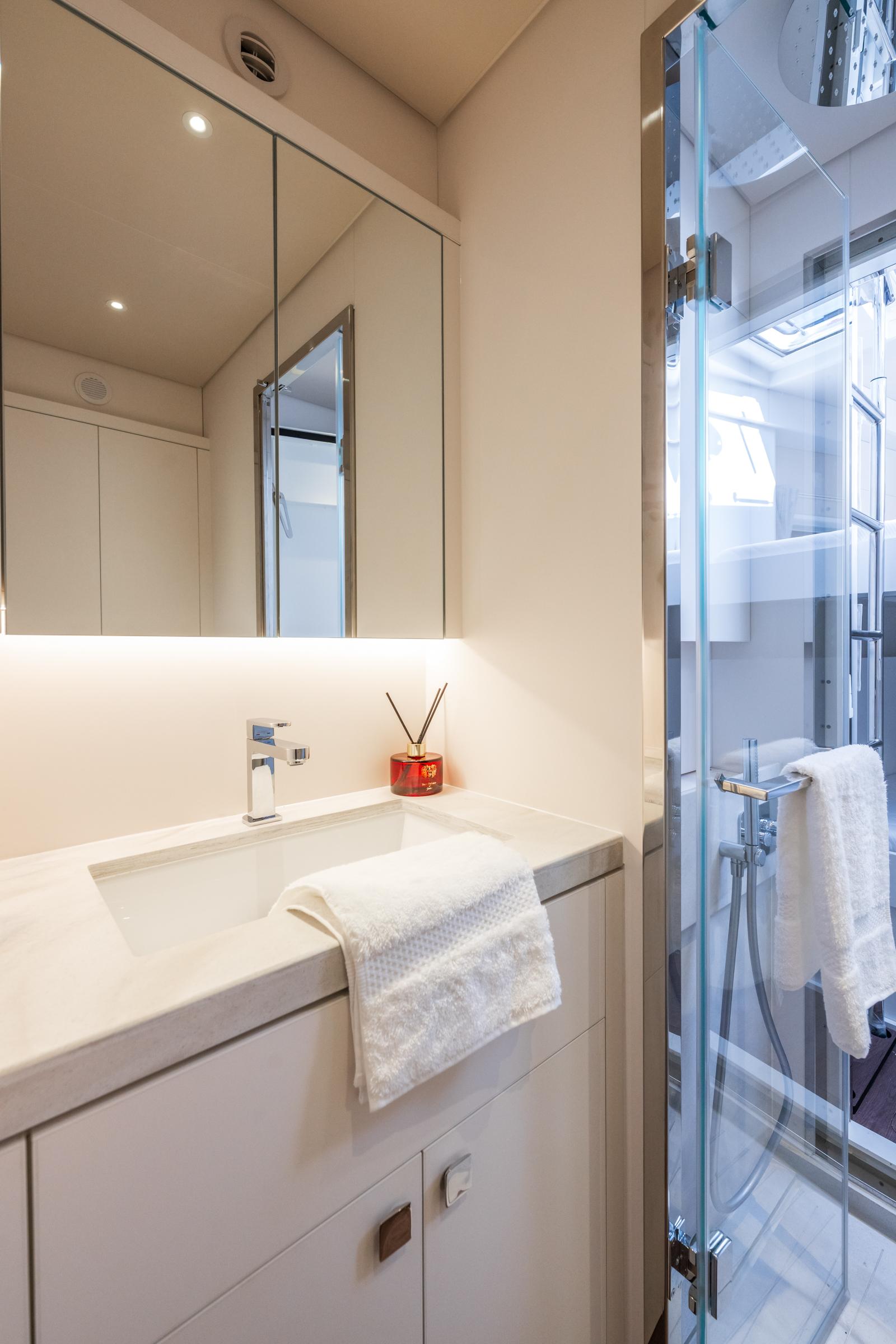 Modern bathroom in 2025 Lagoon Eighty 2 yacht with sleek design and glass shower.