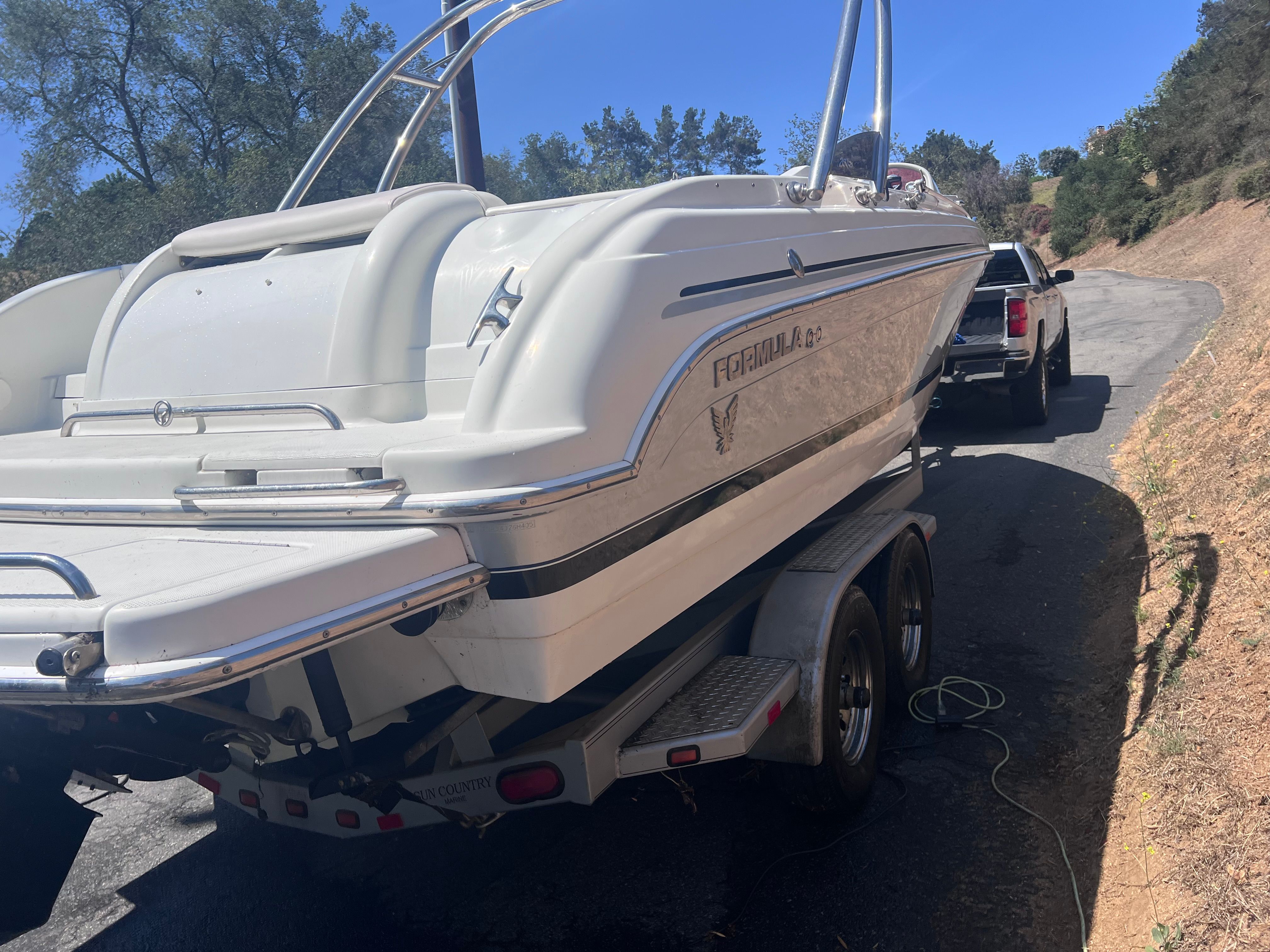 2006 Formula 260 Sun Sport boat on trailer, sunny day.