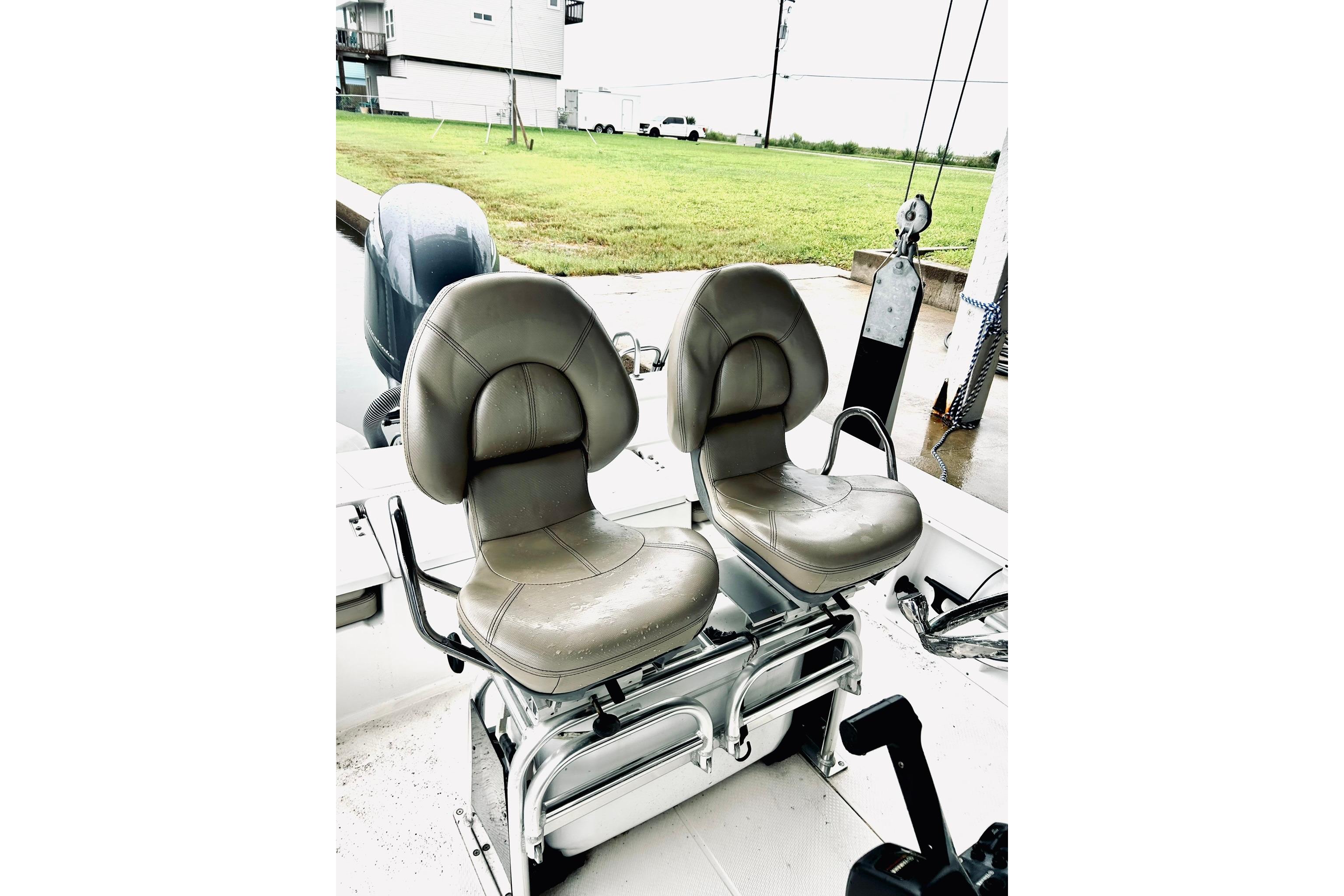 Two cushioned seats on a 2017 Blue Wave 2200 PureBay boat deck.