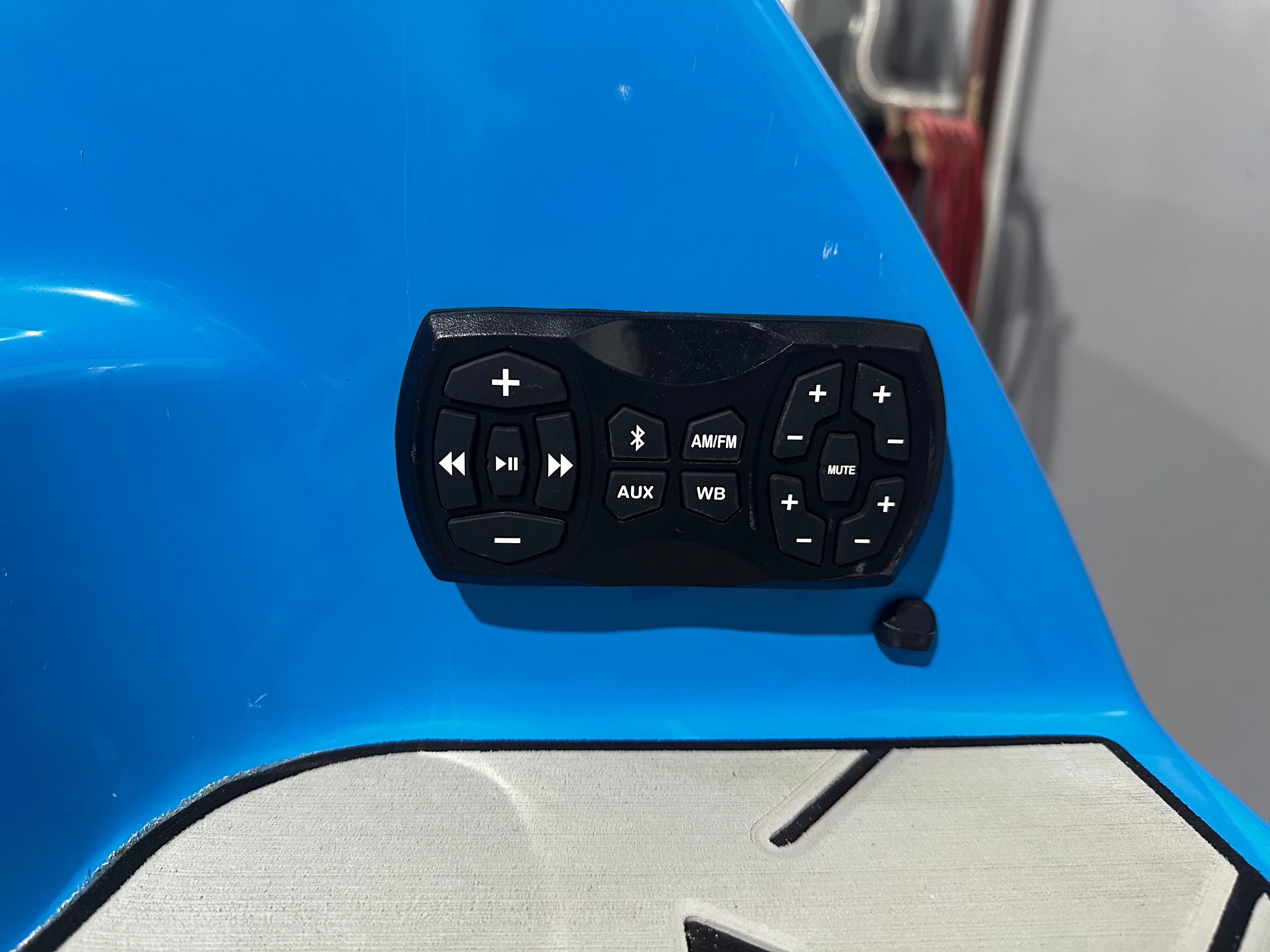 Control panel on 2023 Yamaha Boats 255XD, featuring audio and navigation buttons.