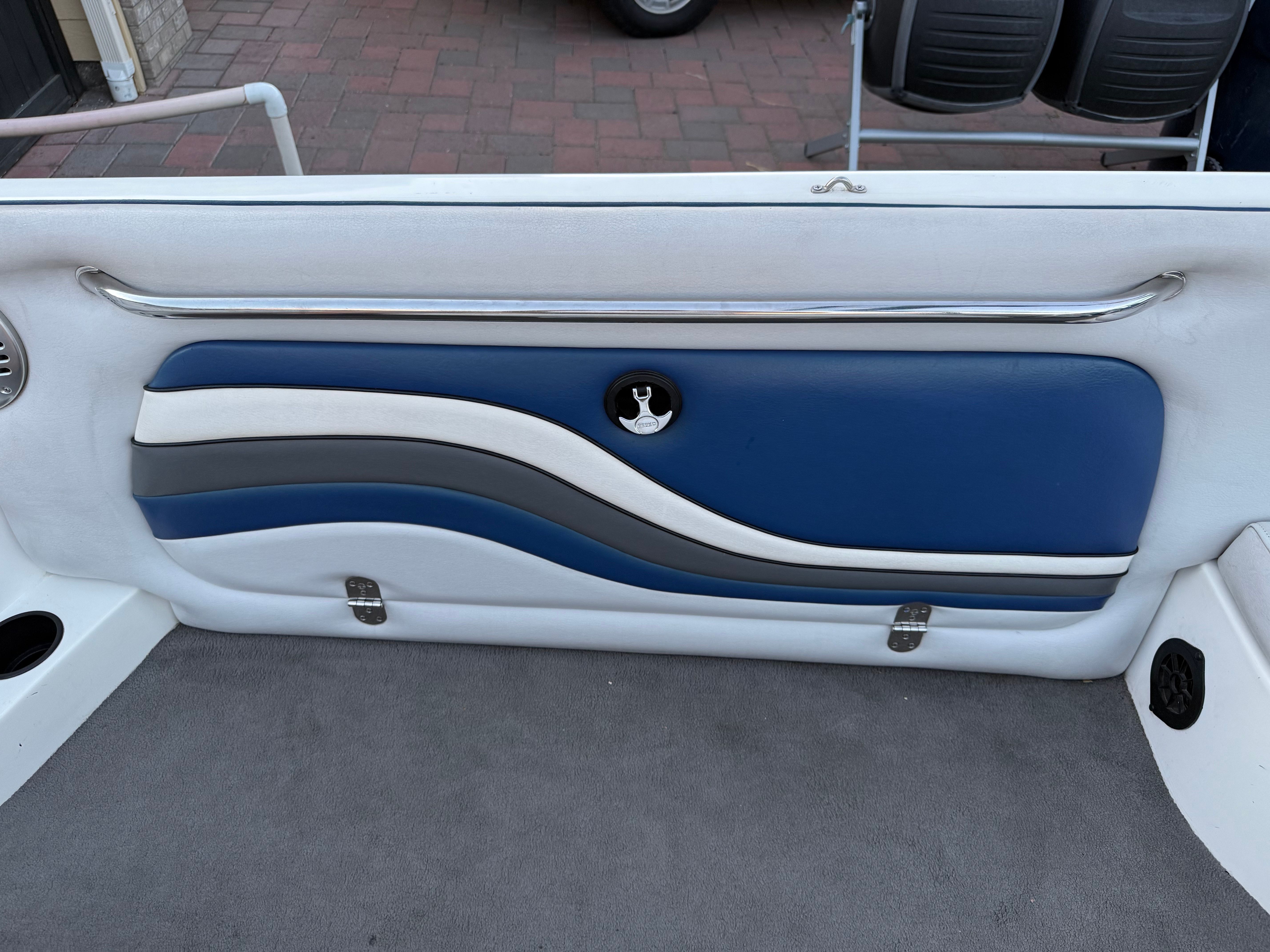 Interior of a 2004 MB Sports 220 boat with blue upholstery.