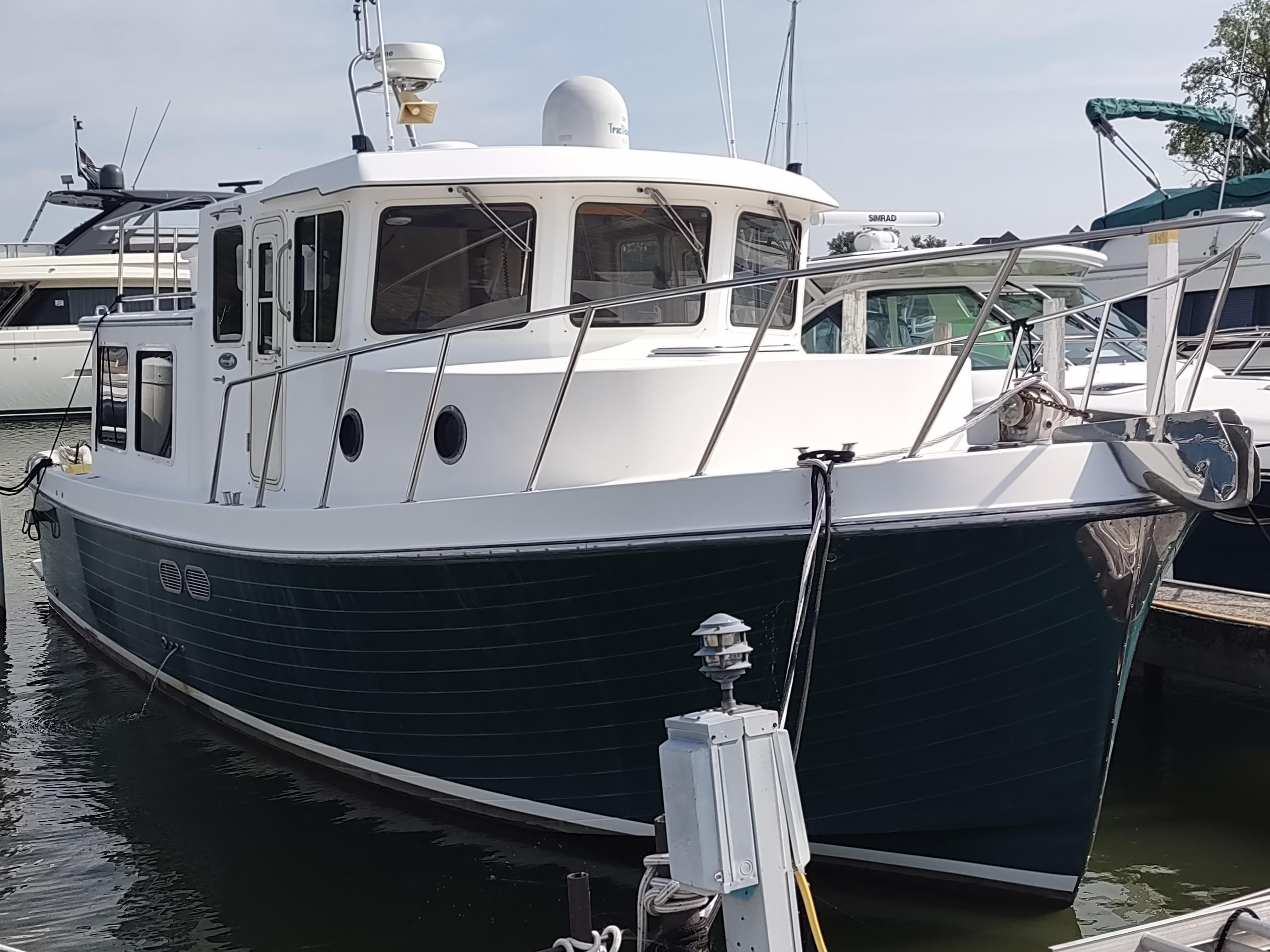 2003 American Tug 34 docked, showcasing classic design and sturdy build.