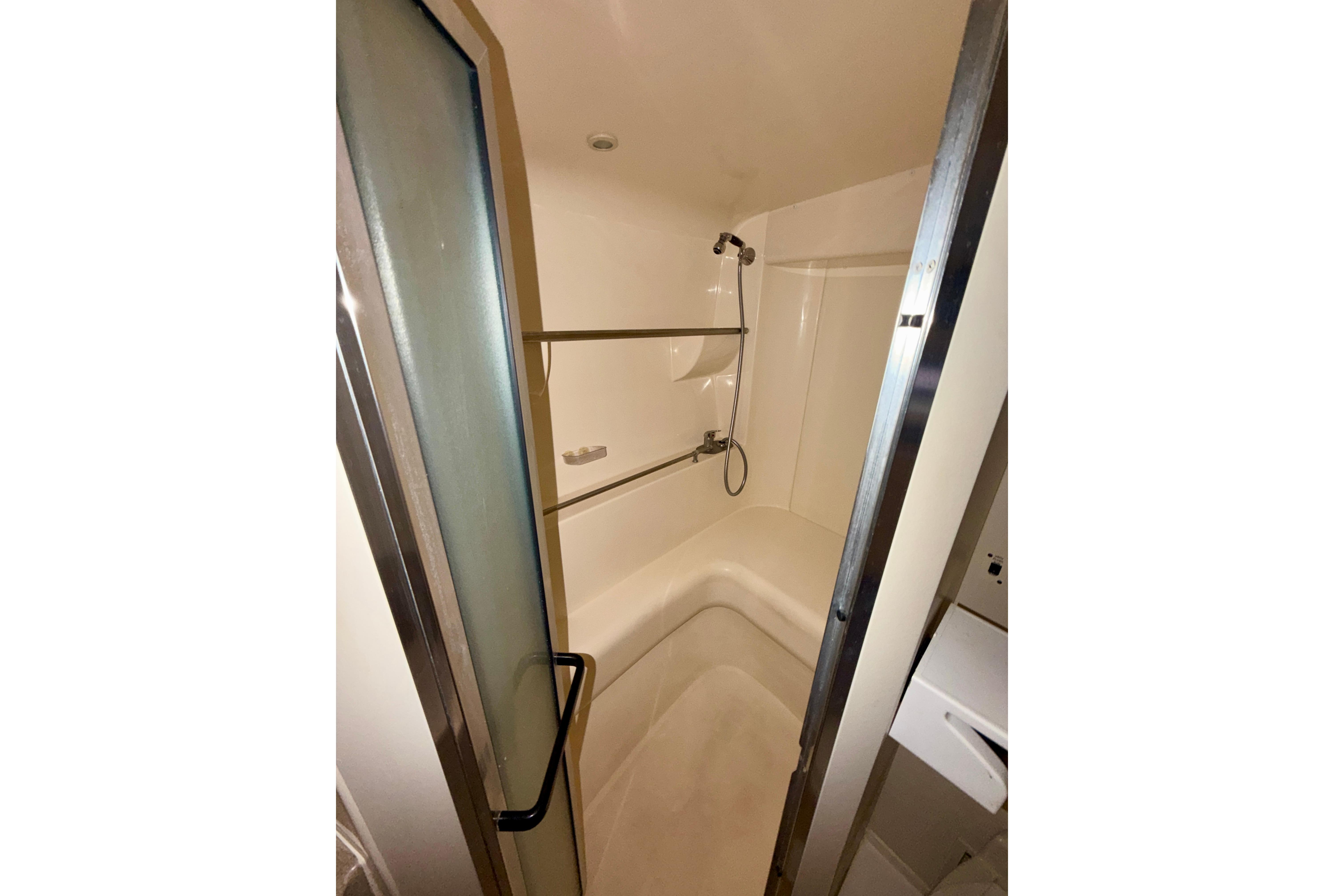 Shower area inside 2000 Carver 350 Mariner yacht, featuring compact design and sliding door.