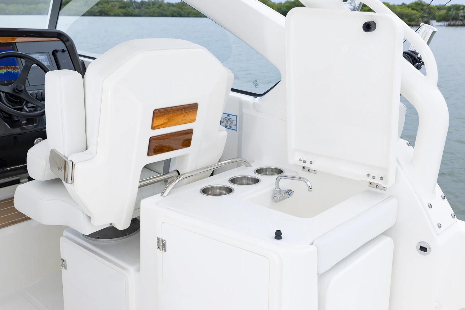 Manufacturer Provided Image: 2026 Pursuit DC 286 Dual Console boat interior with helm seat and sink area.