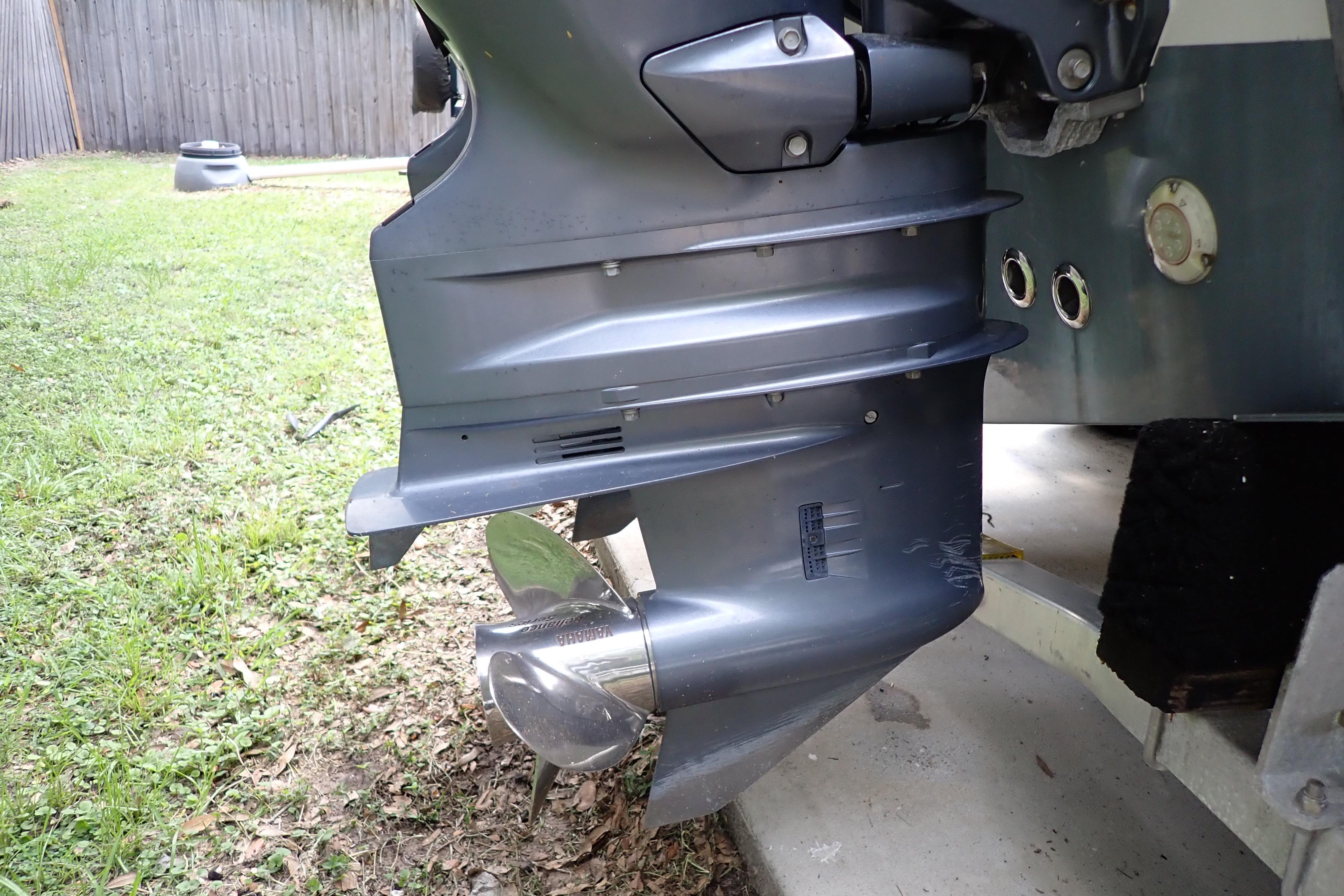 2019 Key West 263 FS boat motor and propeller on grass.