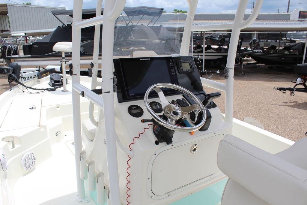 2026 Skeeter SX230 boat cockpit with steering wheel and navigation equipment.