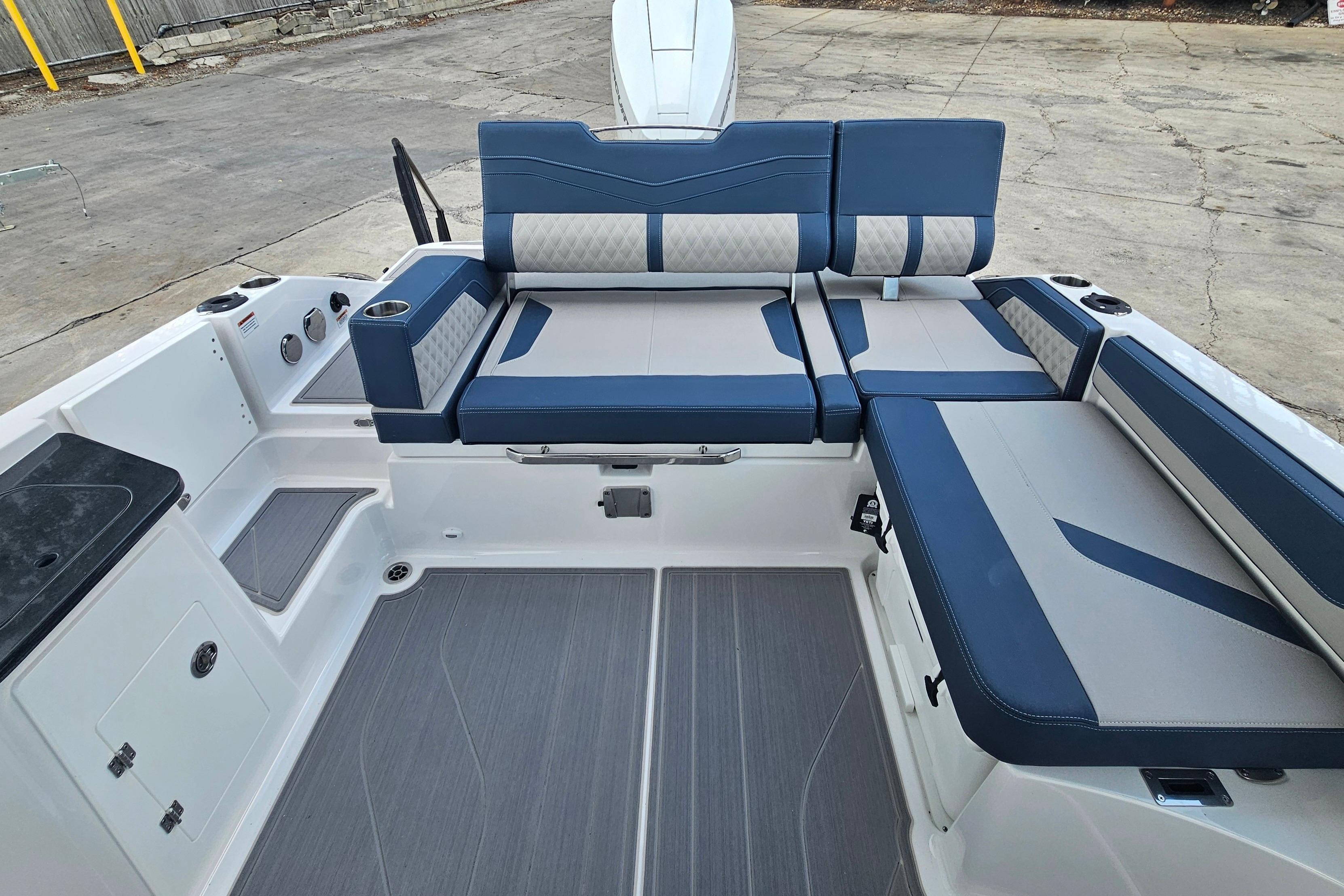 2026 Monterey Elite 27 OB boat interior with blue and gray seating arrangement.