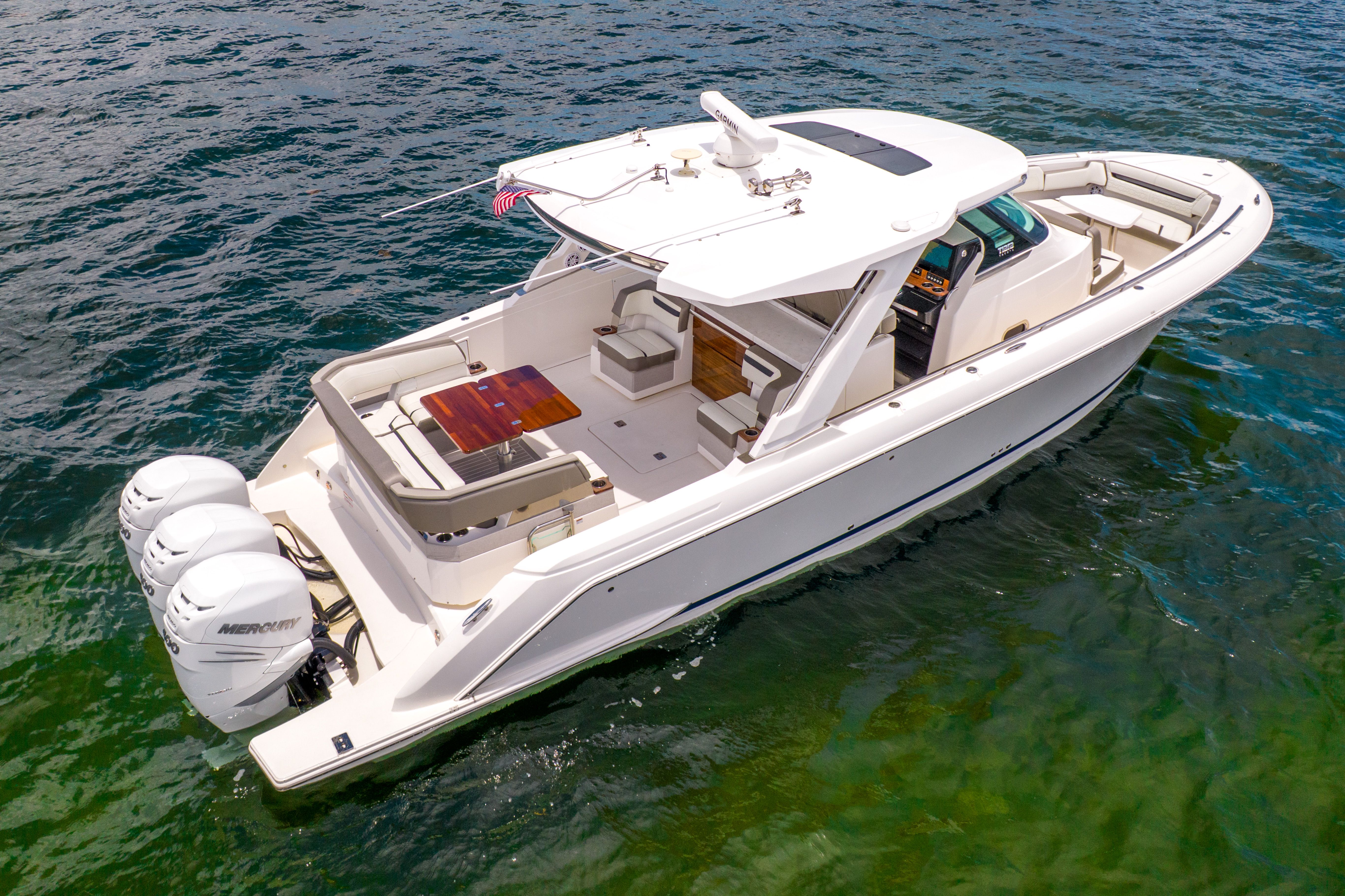 The 2023 Tiara Yachts 38 LS is a sleek motorboat on calm water.