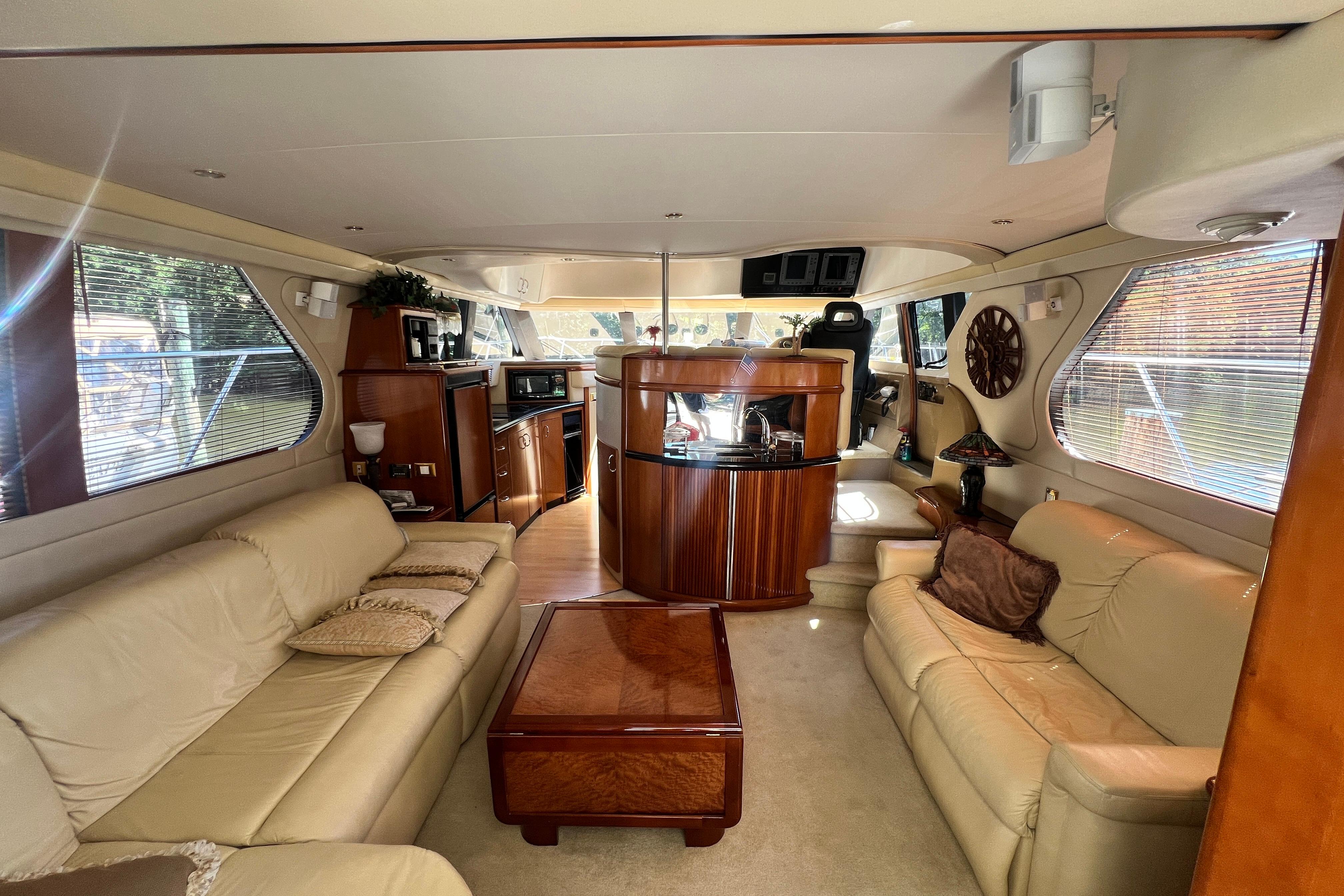 Luxurious interior of 2003 Carver 450 Voyager Pilothouse with leather seating and wood accents.