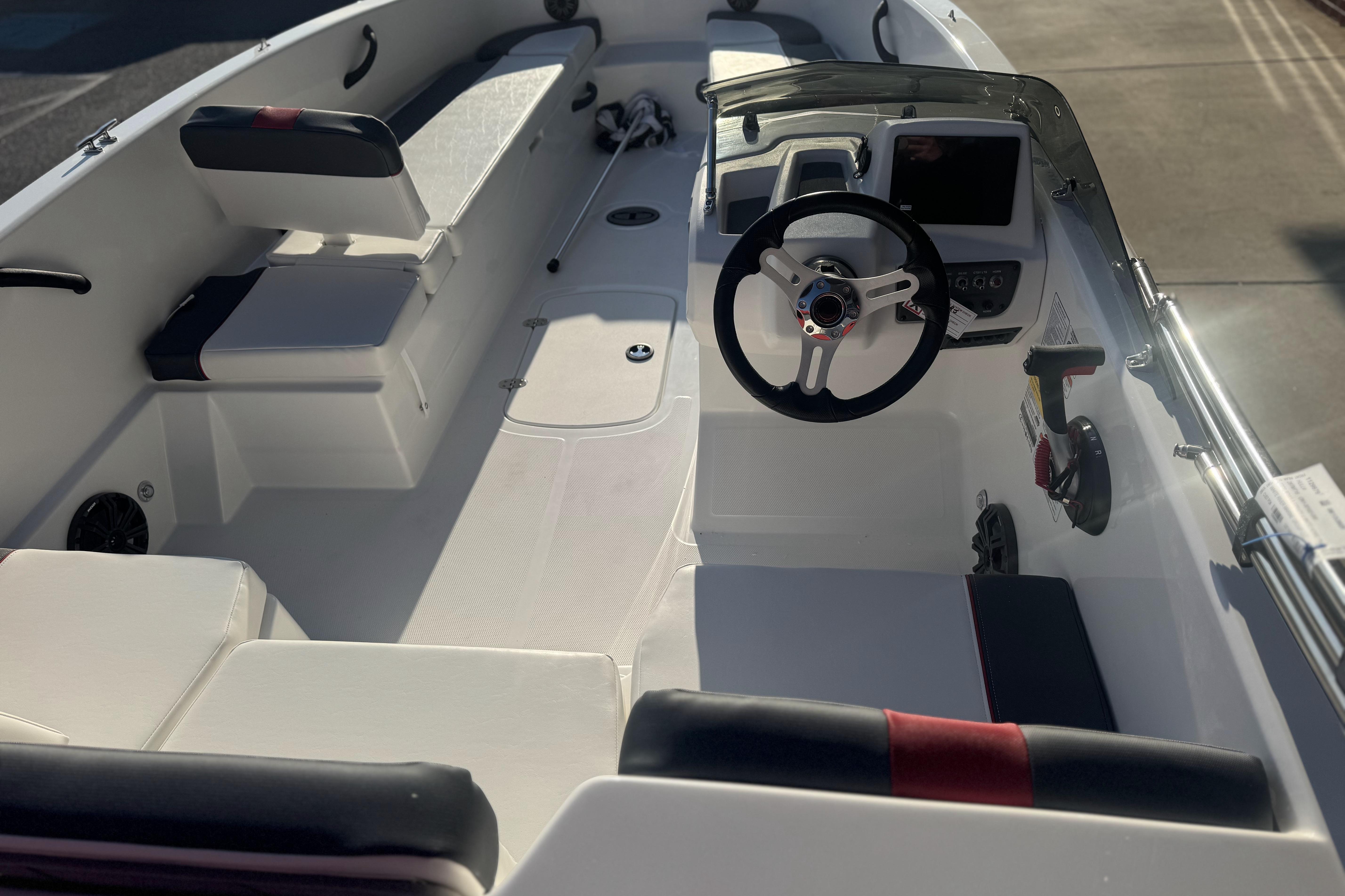 2026 Tahoe T18 boat interior with steering wheel, seating, and control panel.
