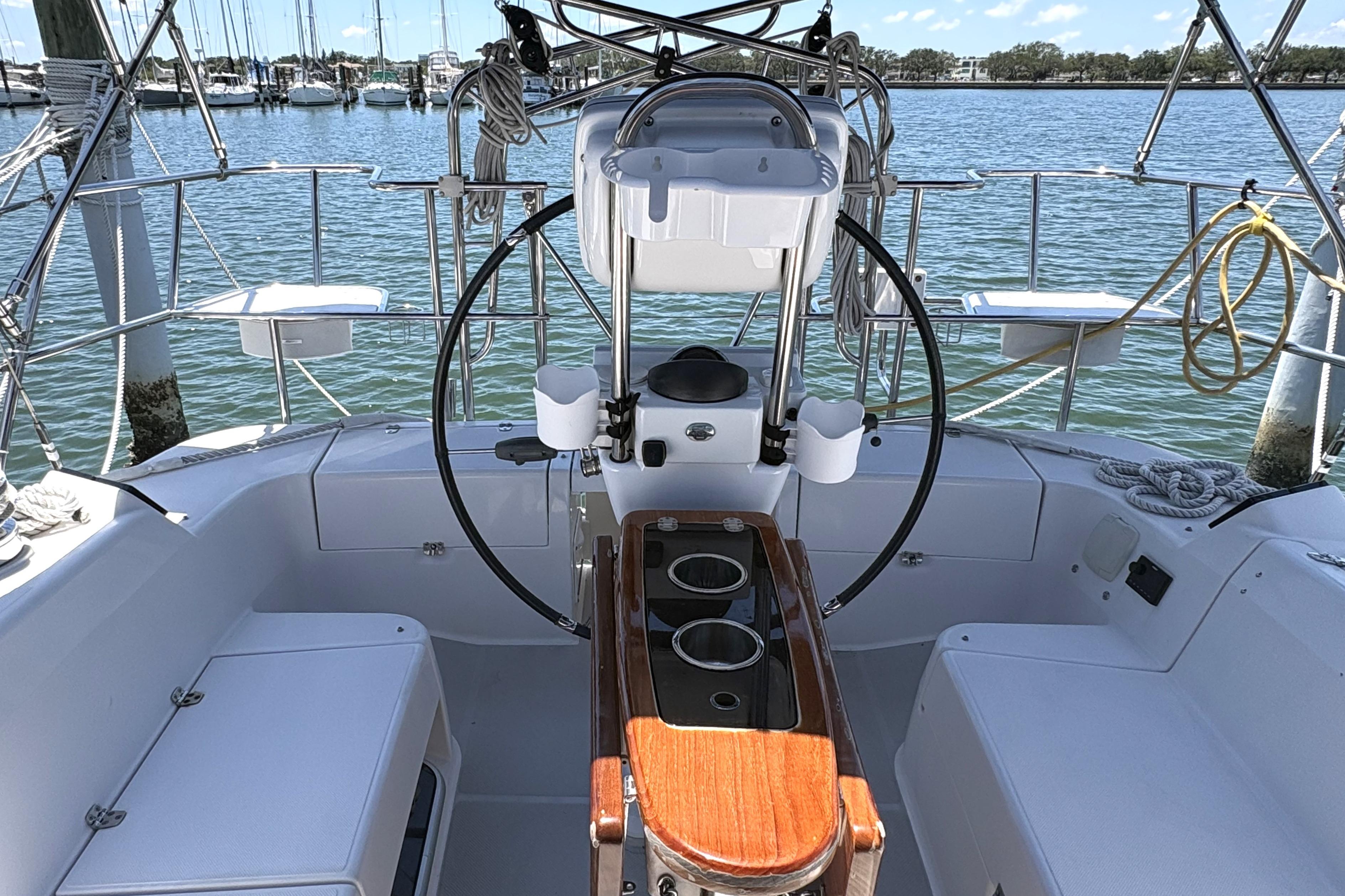 Cockpit of a 2011 Catalina 355 sailboat, featuring a steering wheel and seating.