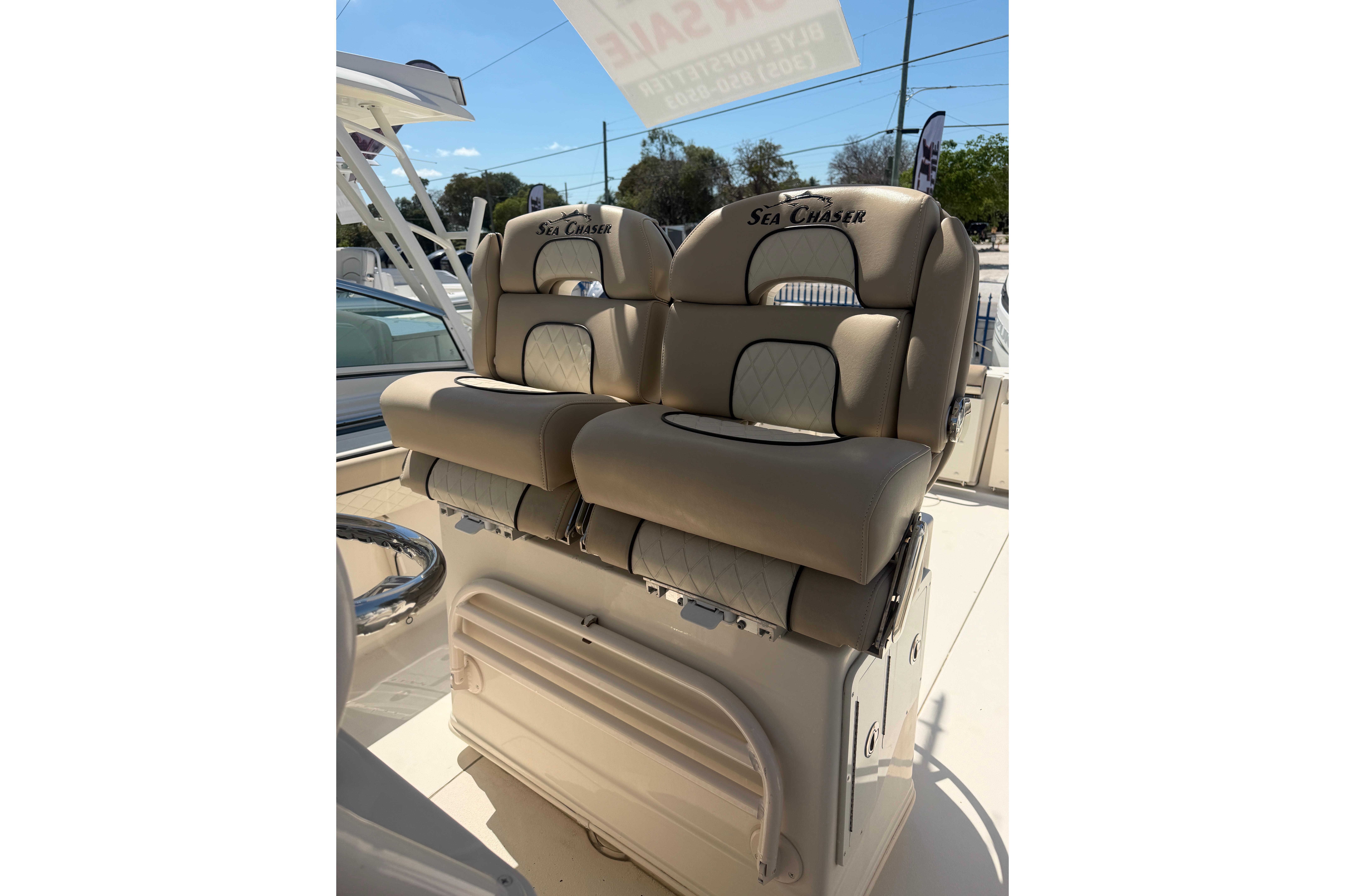2021 Sea Chaser 30 HFC CC boat seats, beige leather, outdoor setting.
