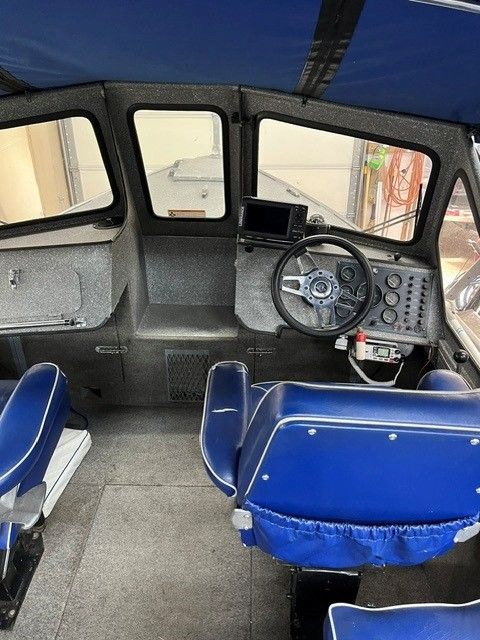 Interior of a 1986 custom jet boat with blue seats.