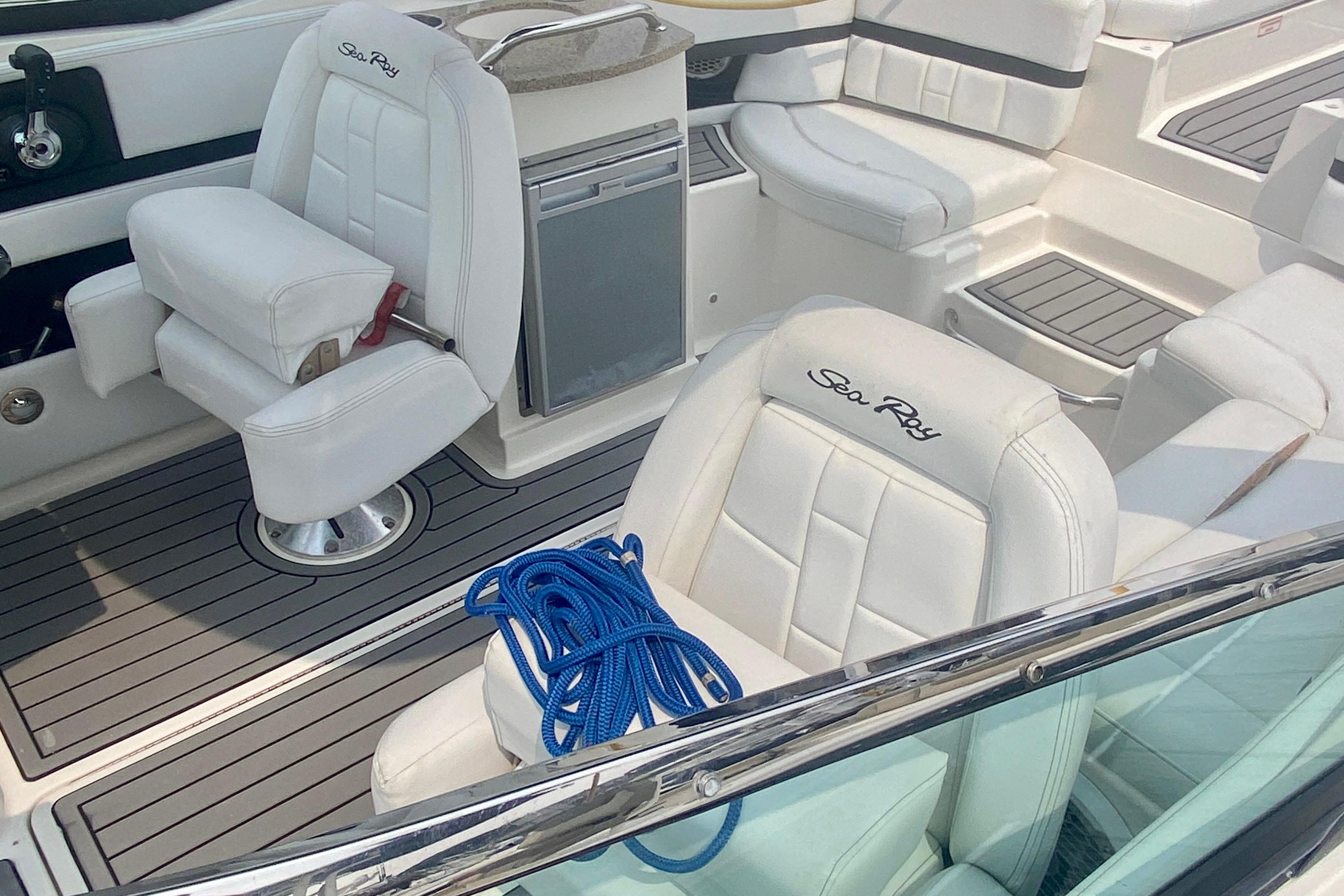 Interior of a 2015 Sea Ray 250 SLX boat with white seating and blue rope.