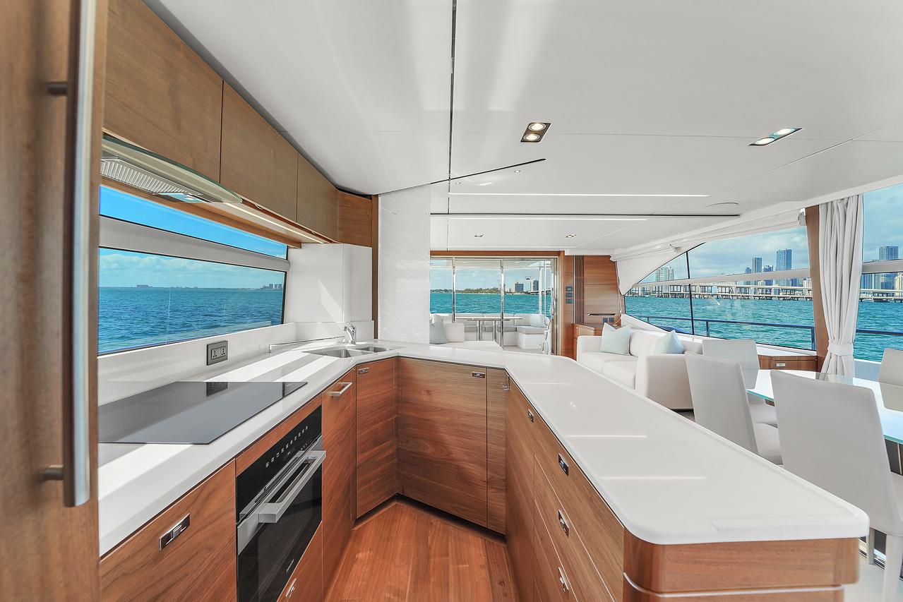 Modern kitchen interior on a 2021 Princess Y78 yacht with ocean view.