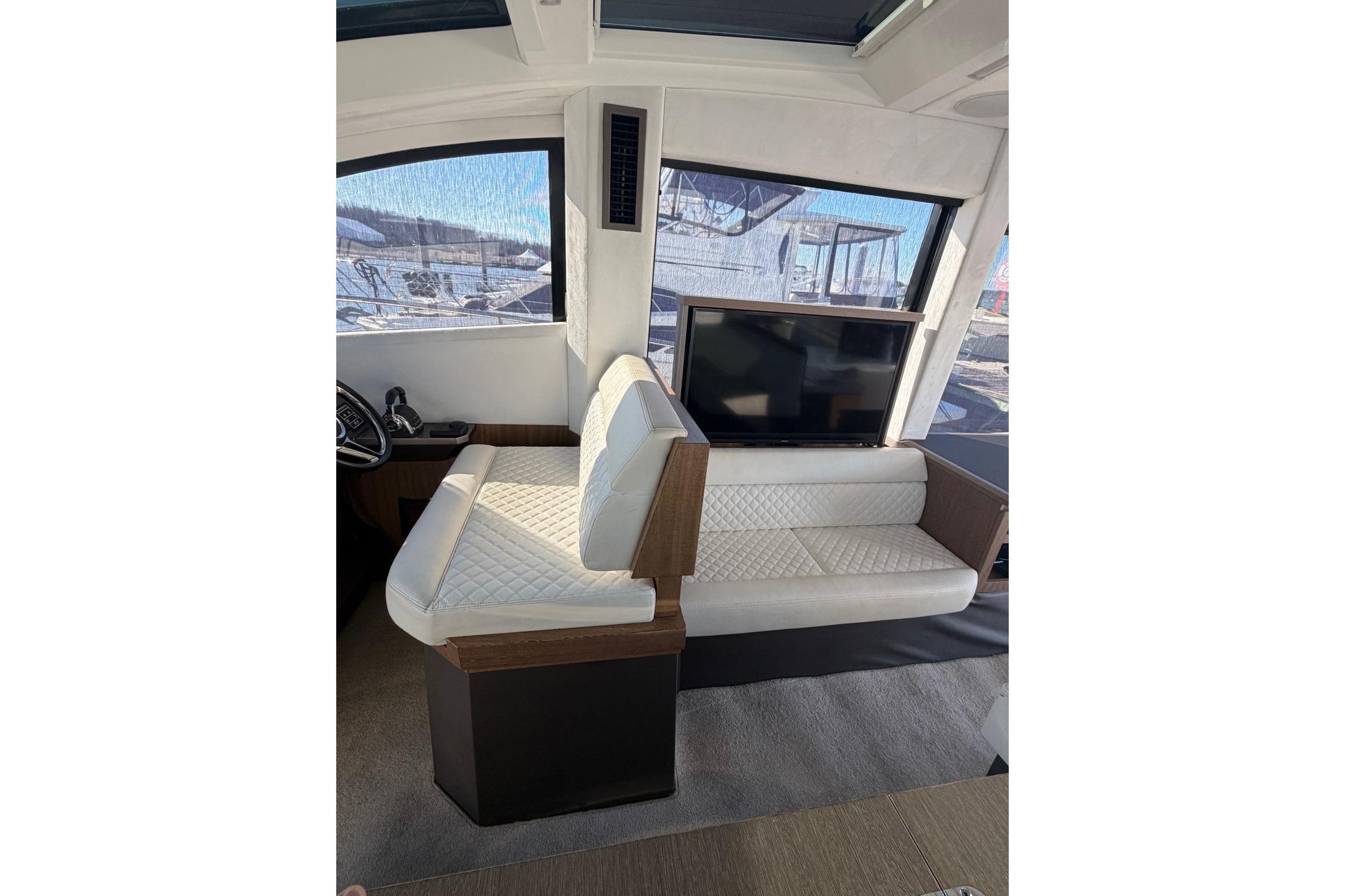 Interior of 2019 Galeon 470 Sky yacht with white seating and large window view.