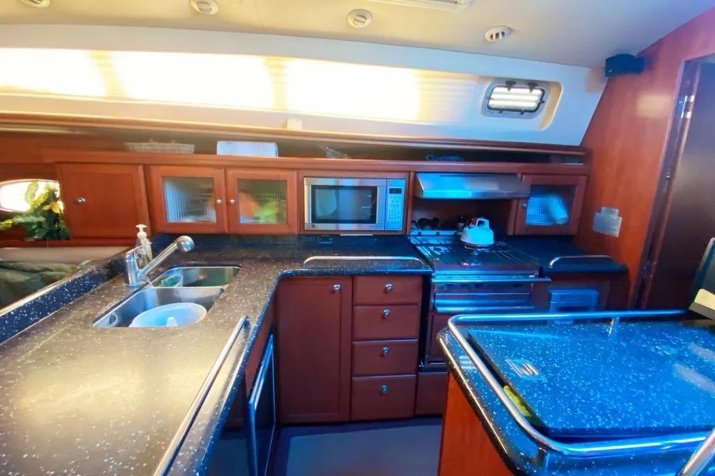 Luxurious 2012 Hunter Aft Cockpit 50 yacht kitchen with modern amenities and sleek design.