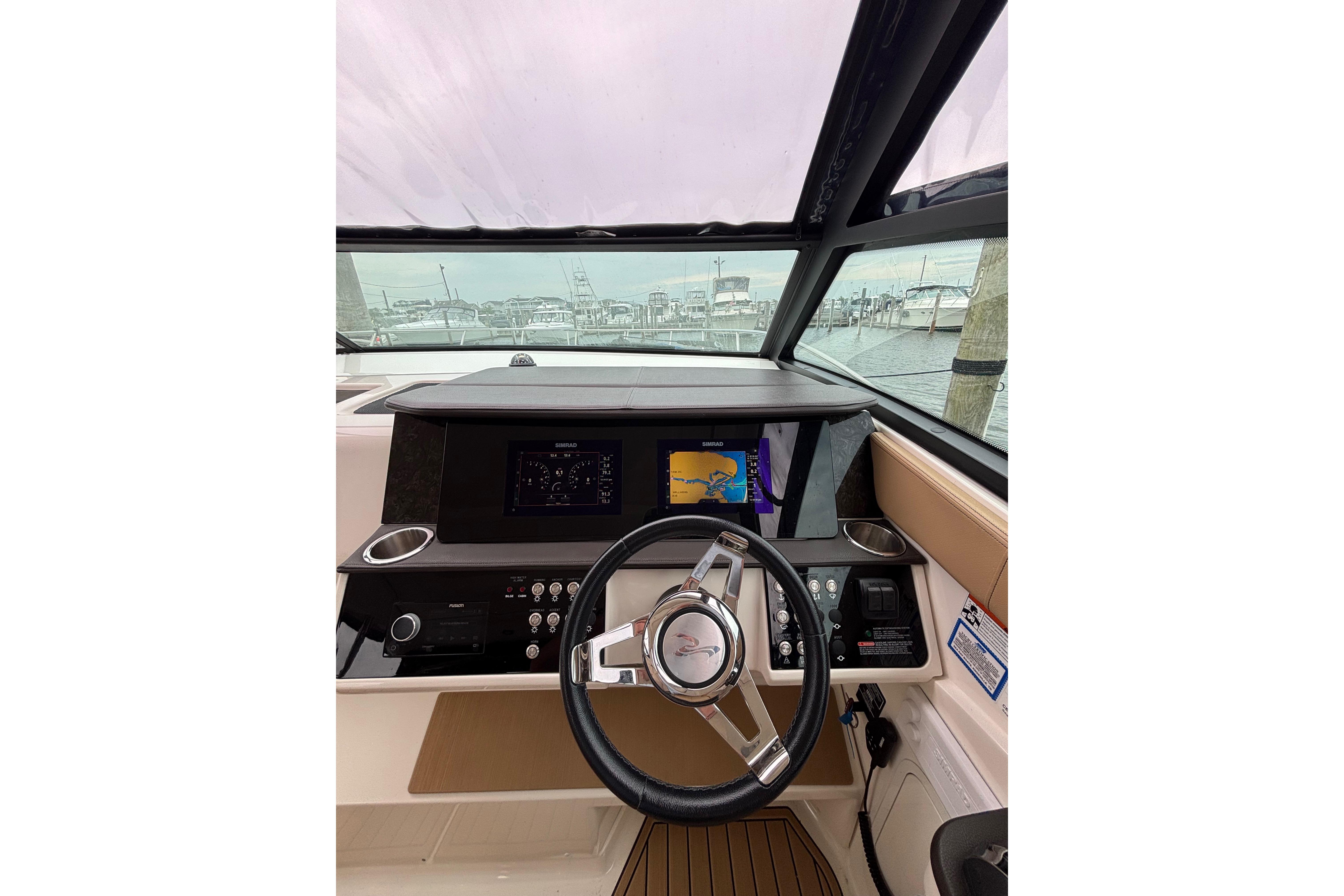 2021 Sea Ray Sundancer 320 Outboard helm with modern navigation display and steering wheel.