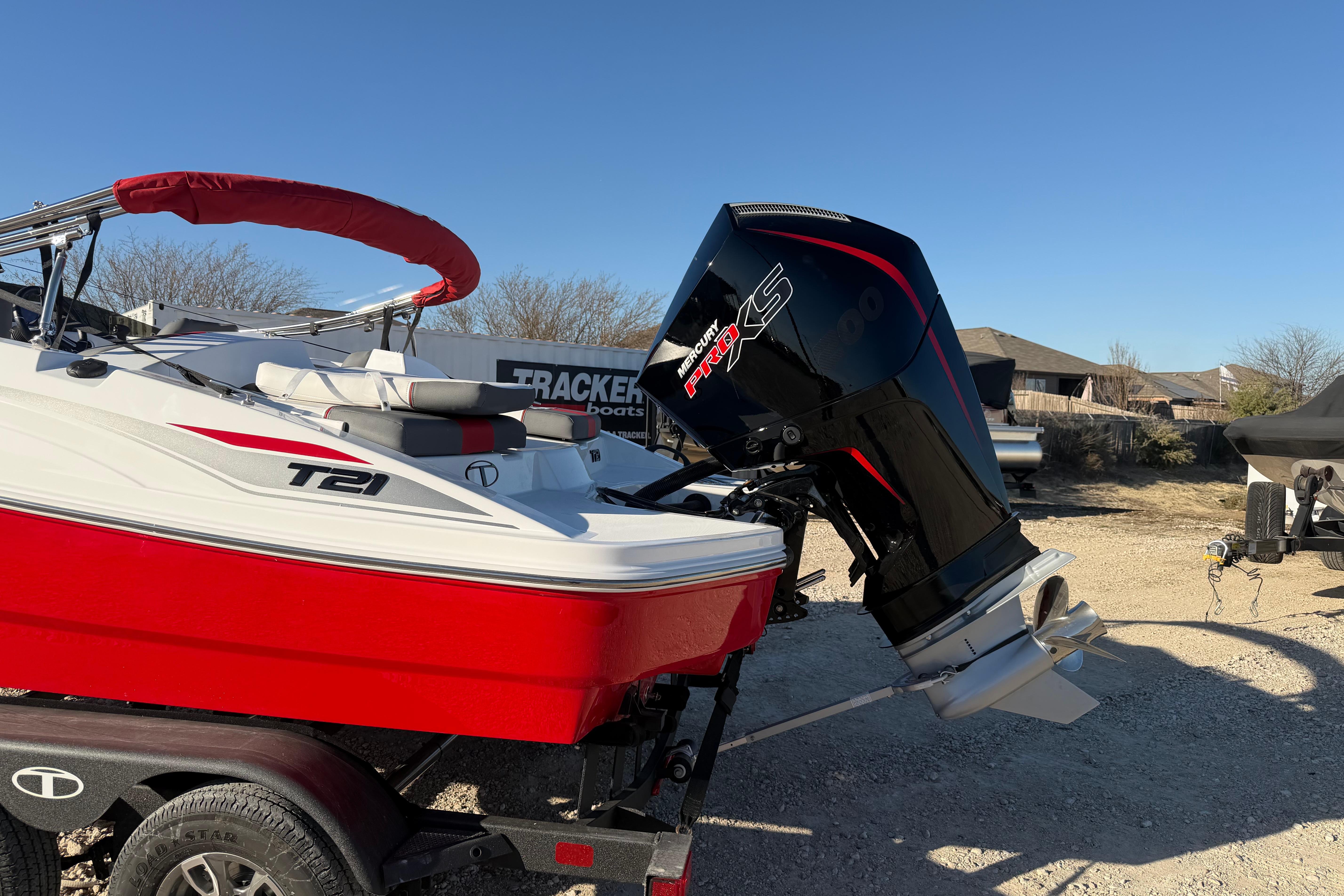2026 Tahoe T21 boat with Mercury Pro XS engine, red and white design, on trailer.