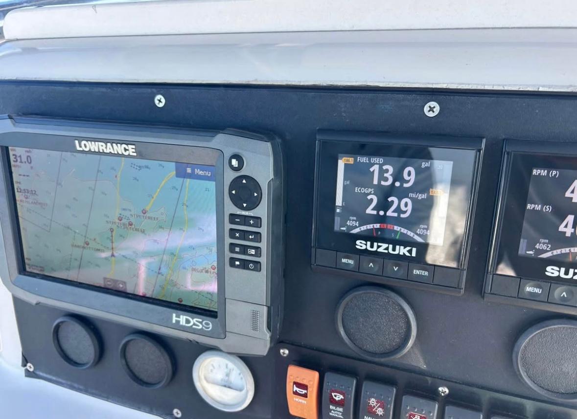 Dashboard of a 1996 Pro-Line 27 CC with Lowrance and Suzuki displays.