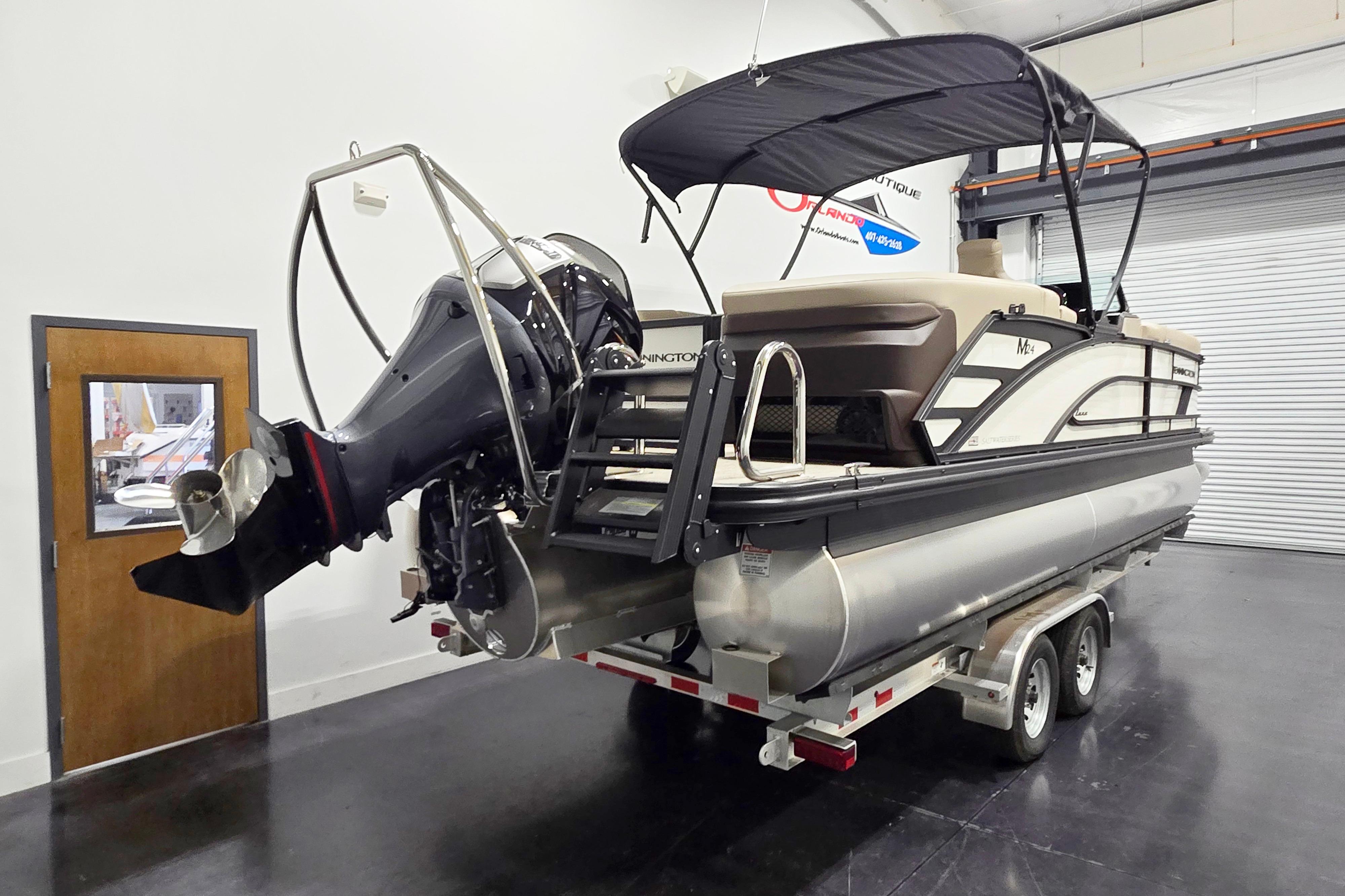 2026 Bennington 24 M pontoon boat on trailer in indoor showroom.