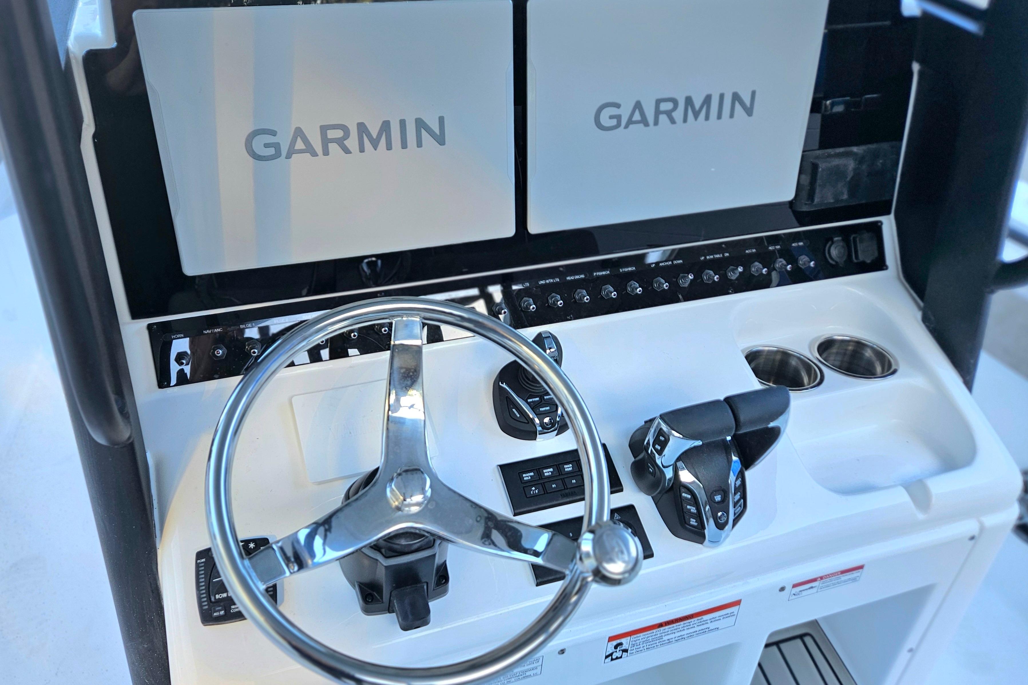 Steering console of 2026 Sea Hunt Ultra 285 SE with Garmin displays.