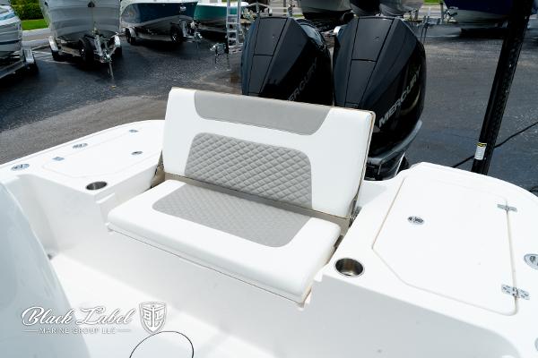 2025 Caymas 281 HB boat with cushioned seating and dual outboard motors.