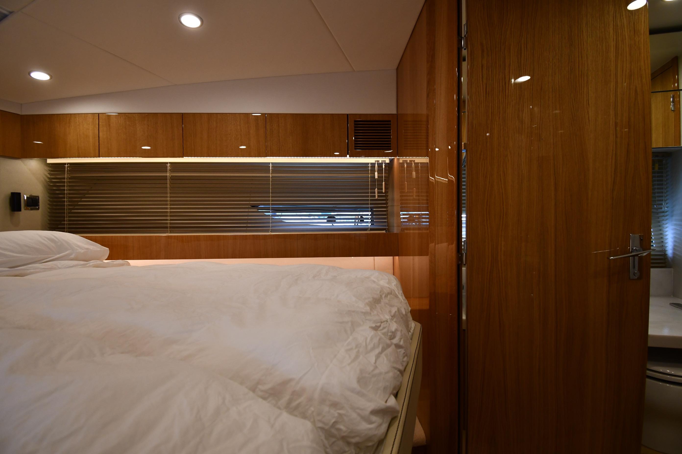 Luxurious cabin interior of 2024 Fairline G50 Targa yacht with elegant wood finishes.