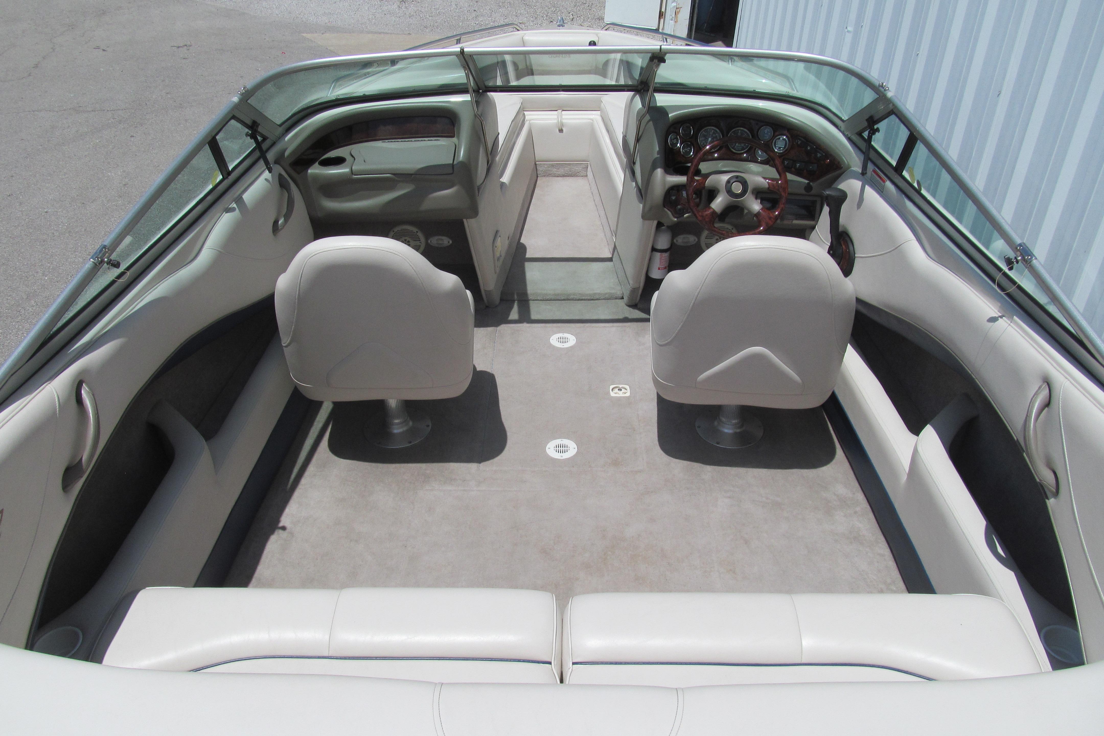 Interior of a 2001 Crownline 225 BR boat, featuring seating and steering console.