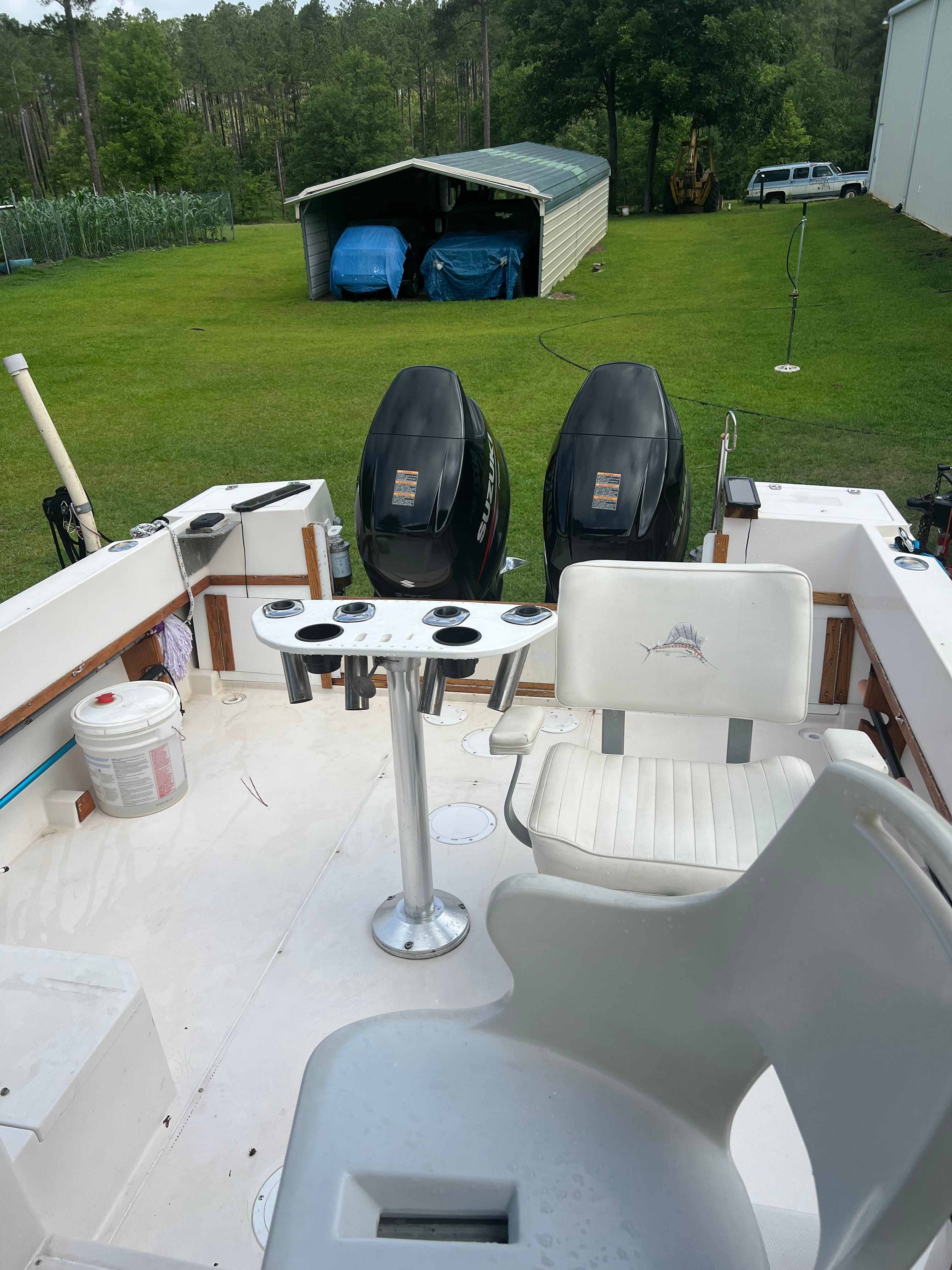 1987 Grady-White Gulfstream boat with dual engines and fishing chair.
