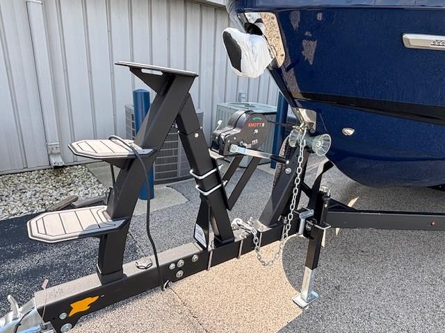 2026 Chaparral SSX 6 boat on trailer, featuring a blue hull and sturdy support system.