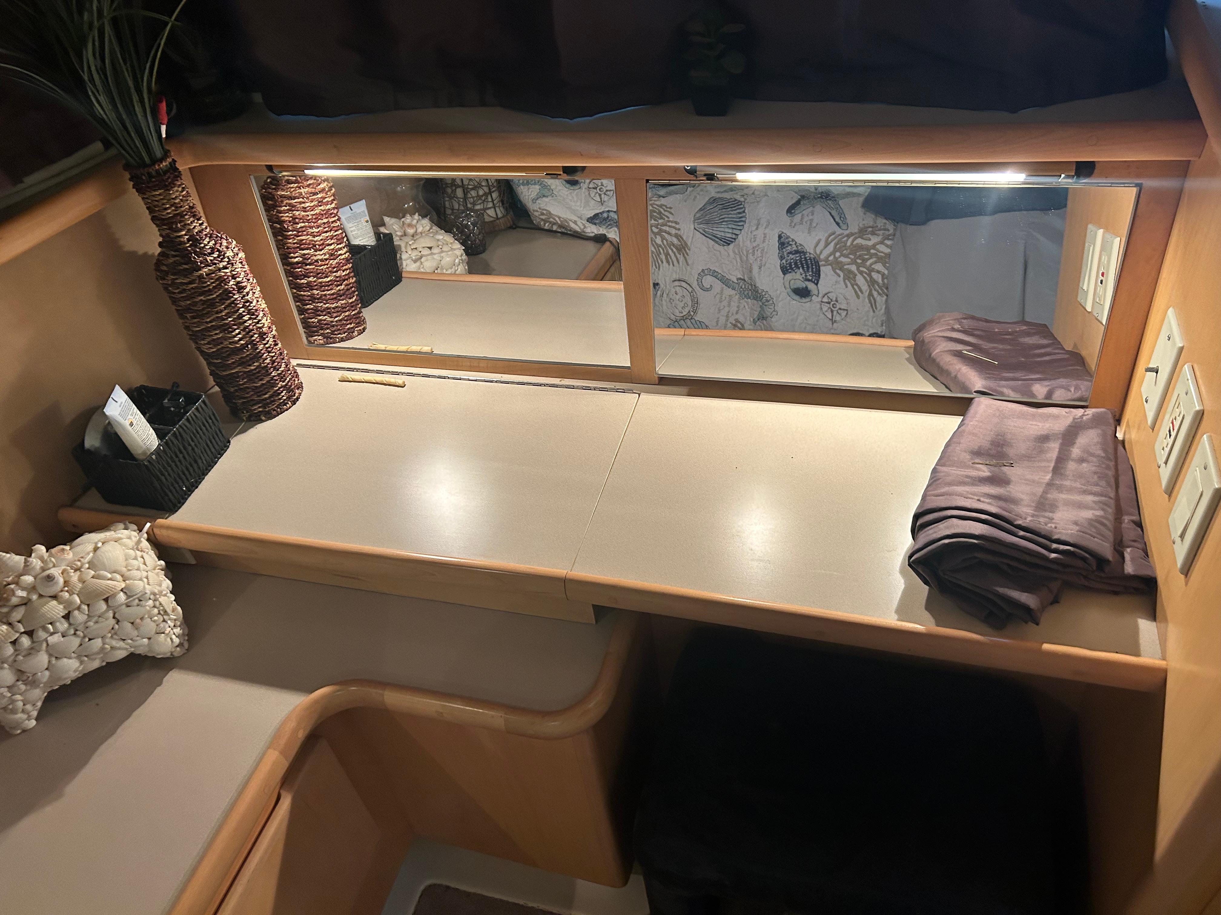 1996 Carver 440 Aft Cabin Motor Yacht interior with vanity, mirror, and decorative elements.