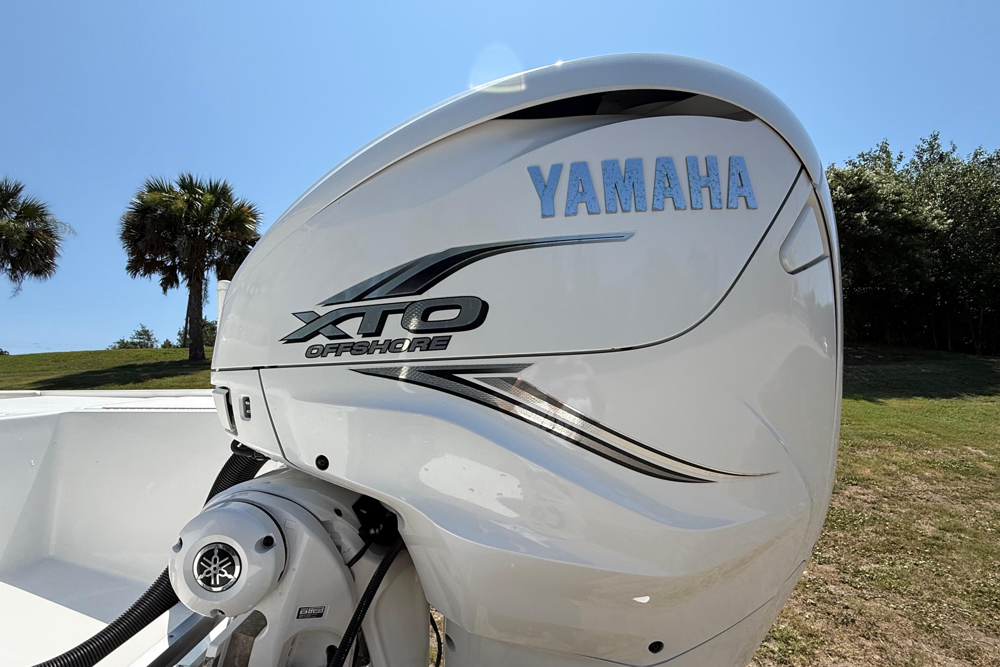 Yamaha XTO Offshore engine on 2023 Regulator 26XO boat, sunny outdoor setting.