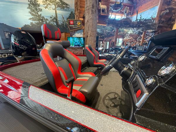2025 Nitro Z19 boat interior with red and gray seats, steering wheel, and dashboard.