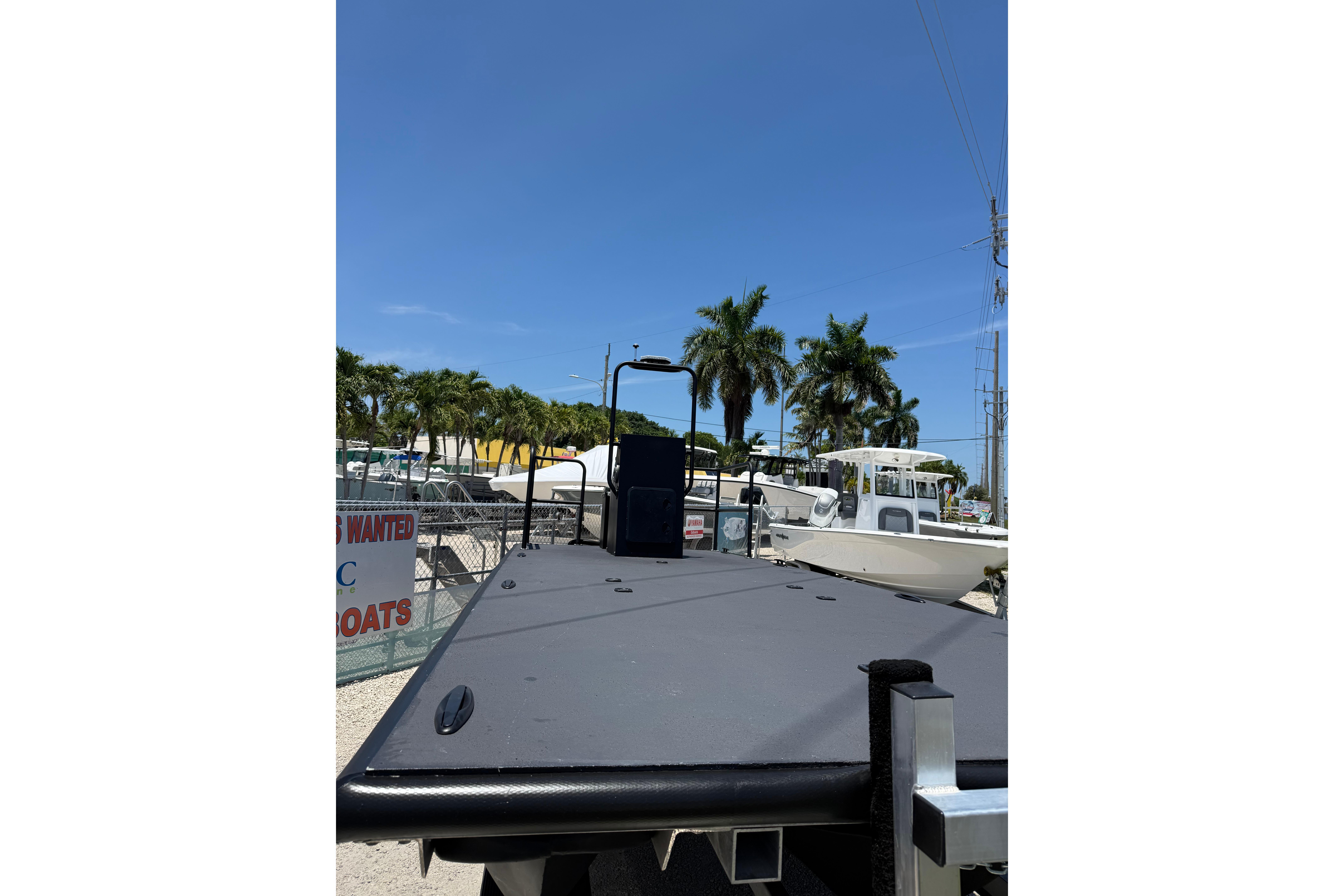 2026 Tough 20 boat on display with palm trees and clear sky background.