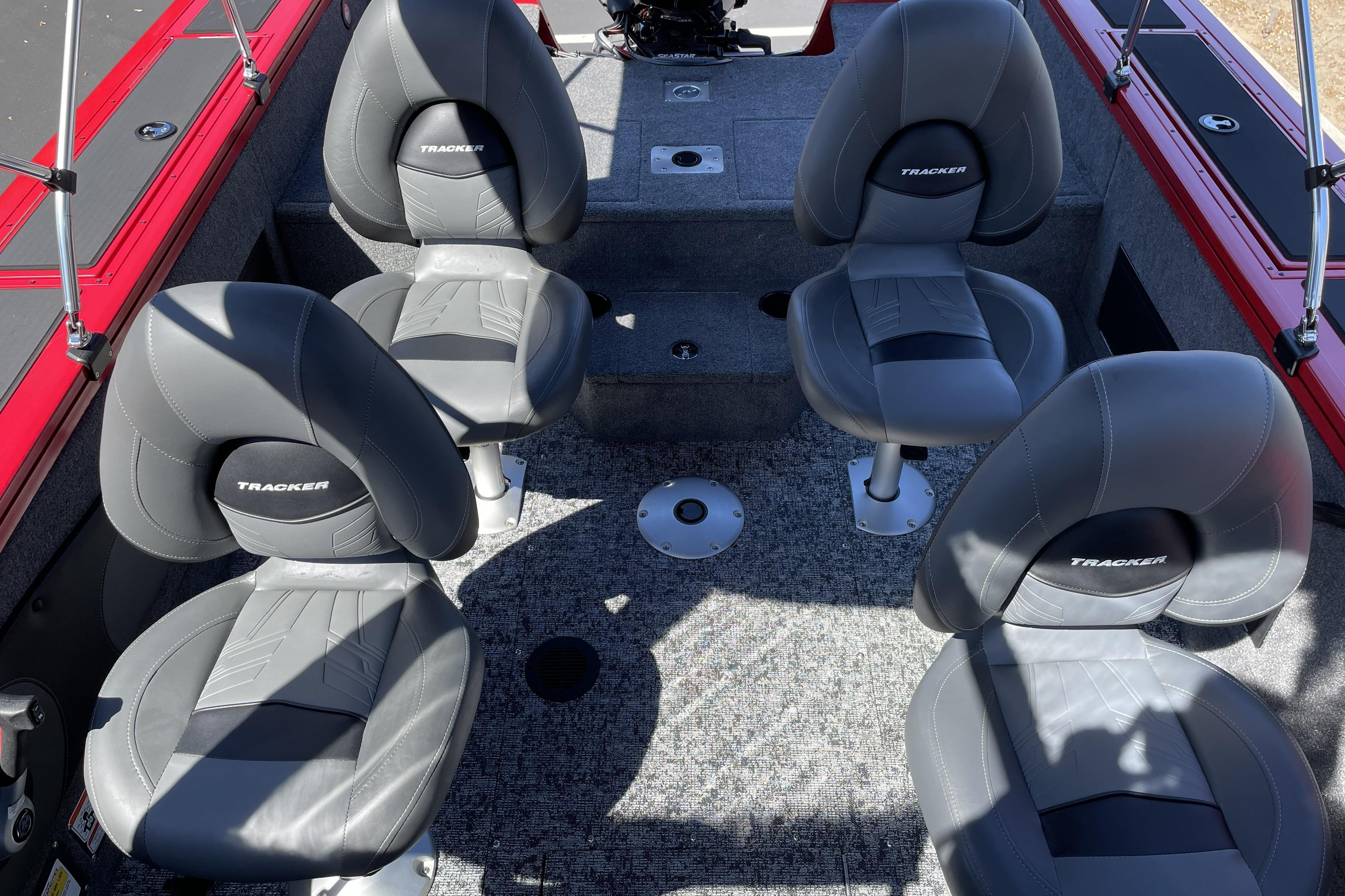 2026 Tracker Targa V-18 WT boat interior with four gray seats and red accents.