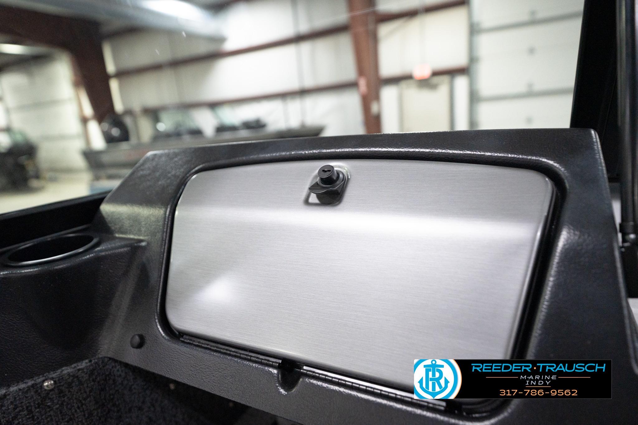 Interior view of 2026 Lund 1800 Explorer Sport boat dashboard in a showroom.