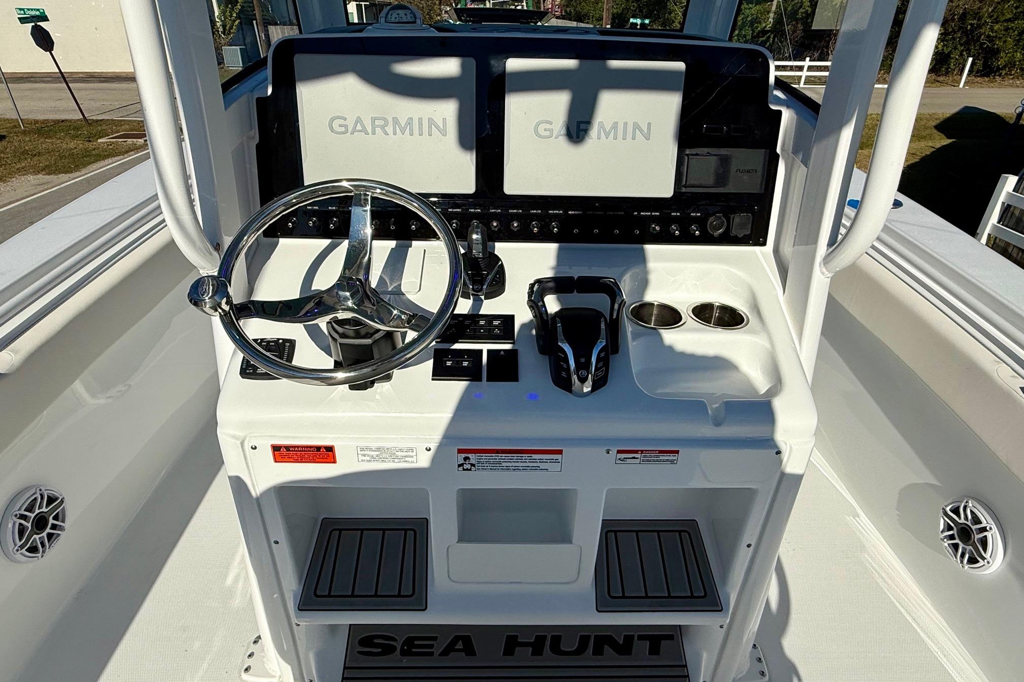 2026 Sea Hunt Ultra 275 Coffin Box boat dashboard with Garmin displays and steering wheel.